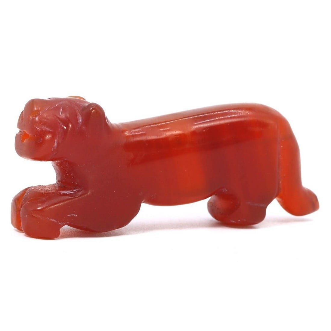 An Antique Himalayan Carnelian Zoomorphic Tiger Amulet, 18th Century: This carnelian tiger amulet from the 18th century embodies the vibrant cultural essence of the Himalayan region. Not ancient but of notable antique grade, the amulet showcases the enduring artistic pr