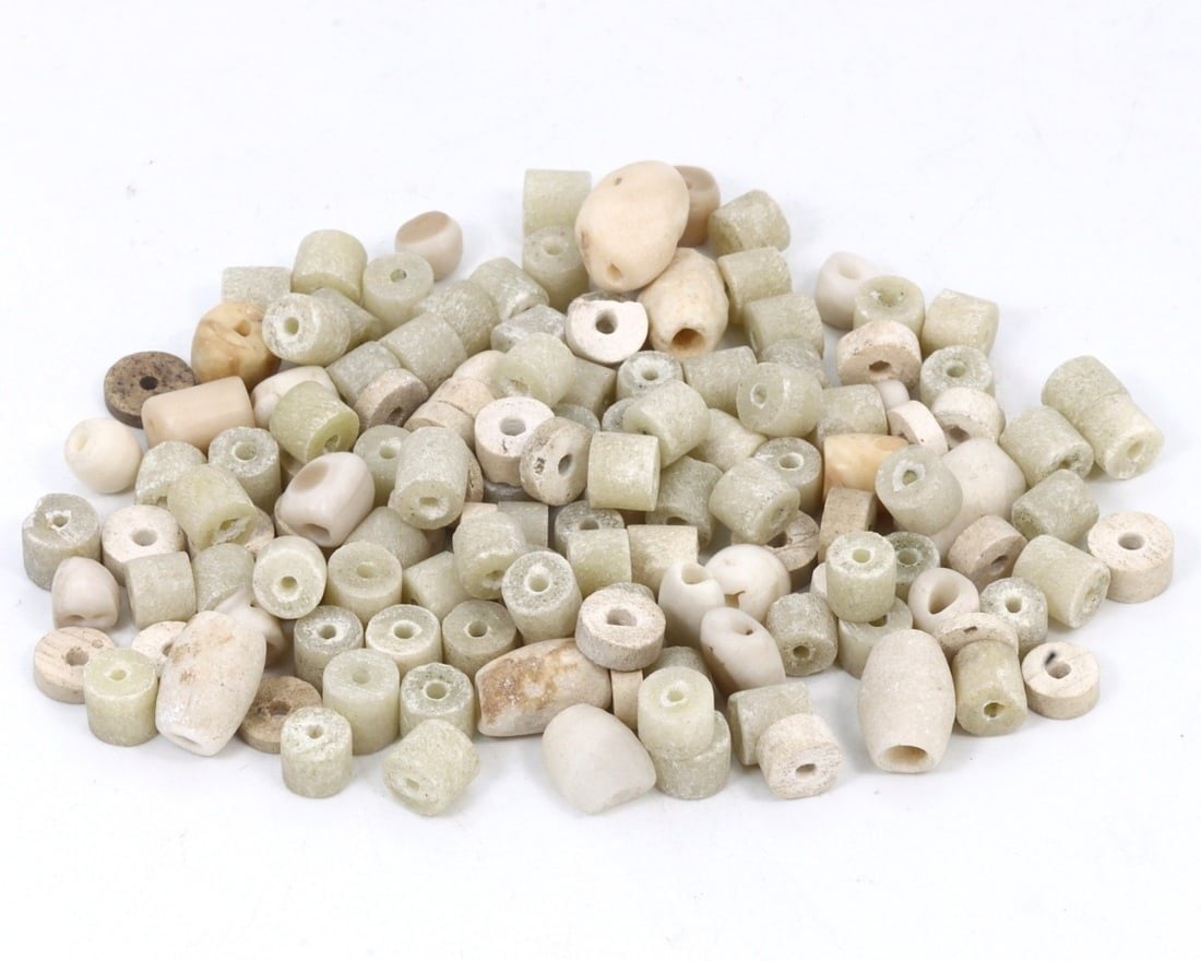 Lot of Antique Kushan Stone and Glass Beads, c. 1st-3rd Century CE: This lot of antique beads, made from beige, celadon, and taupe stone and glass. Dating back to the Kushan period (c. 1st-3rd Century CE), it exemplifies the intricate craftsmanship and vibrant trade n
