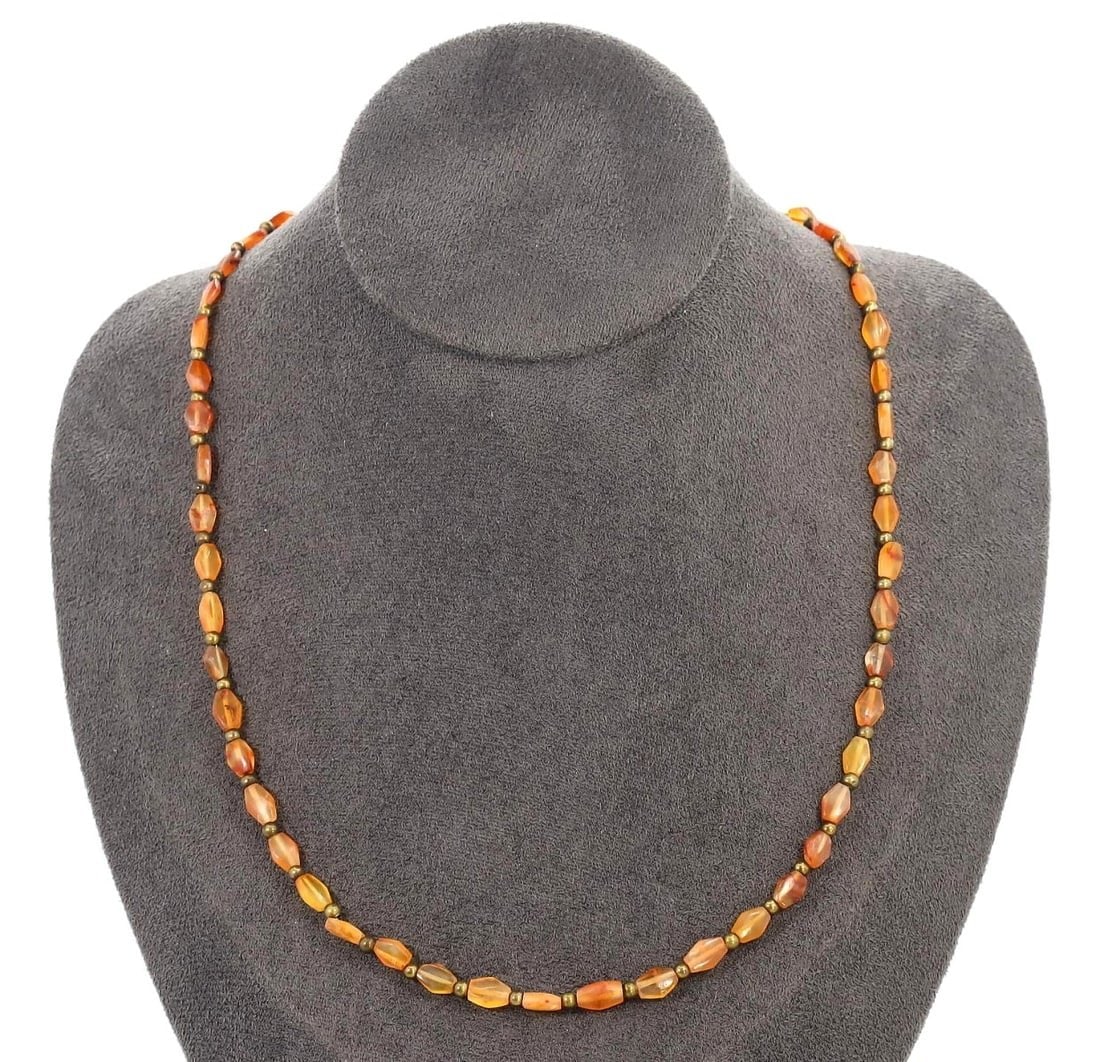 An Antique Carnelian Beaded Necklace, Mughal Empire, 18th Century: Showcasing the opulence of the Mughal Empire, this carnelian beaded necklace from the 18th century reflects the luxury and intricate craftsmanship of the period. Carnelian, valued for its vibrant colo