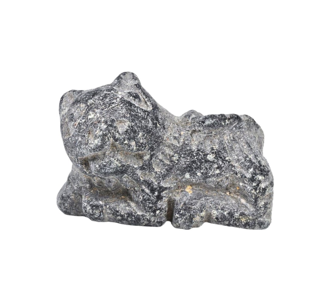 An Ancient Mesopotamian Steatite Feline Figurine, Neo-Sumerian Period: This steatite feline figurine from the Neo-Sumerian period exemplifies the craftsmanship and animal symbolism prominent in ancient Mesopotamian culture. Feline figures were often associated with prote