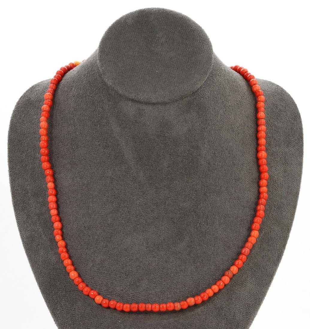 A Vintage European Monochrome Glass Beaded Necklace, Mid-20th Century: This vintage European glass beaded necklace from the mid-20th century features uniformly sized monochrome beads in a striking red hue. Representing the simplicity and elegance of mid-century fashion, 
