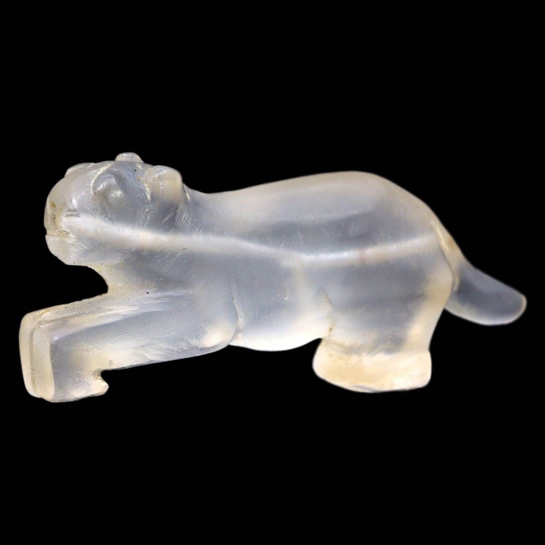 An Antique Himalayan Crystal Zoomorphic Tiger Amulet, 18th Century: Crafted in the 18th century, this Himalayan crystal tiger amulet captures the cultural significance of the tiger in local mythology as a symbol of strength and protection. The clear crystal medium enh