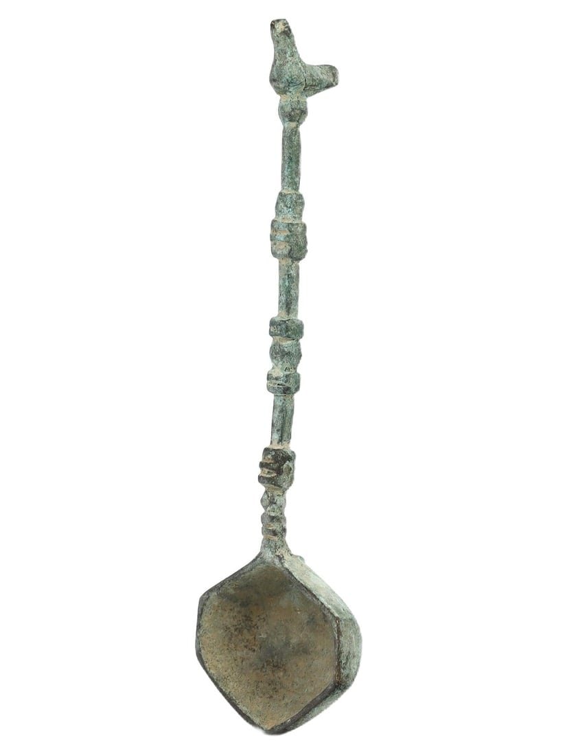An Islamic Bronze Spoon with Intricate Patterns, c. 10th-12th Century CE: This bronze spoon, adorned with intricate patterns, dates back to the Islamic period, circa 10th to 12th century CE. The detailed design and craftsmanship reflect the rich artistic heritage of Islamic