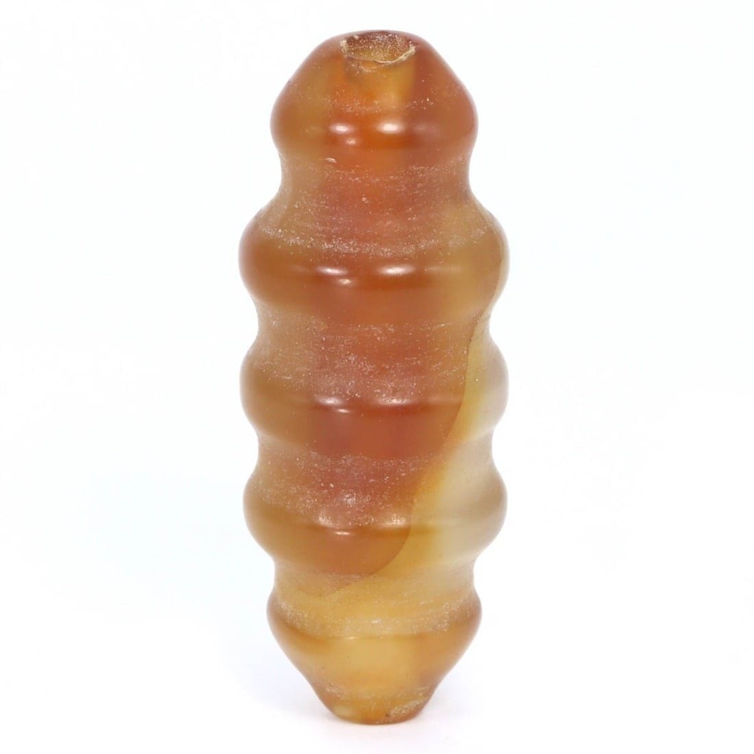 Ancient Sassanian Carnelian Spiral Bead, c. 224-651 CE: This striking 4.3 x 1.5 cm carnelian bead from the Sassanian period showcases a sophisticated spiral design, indicative of the high level of artisanal skill and aesthetic sensibility of the era. Its r