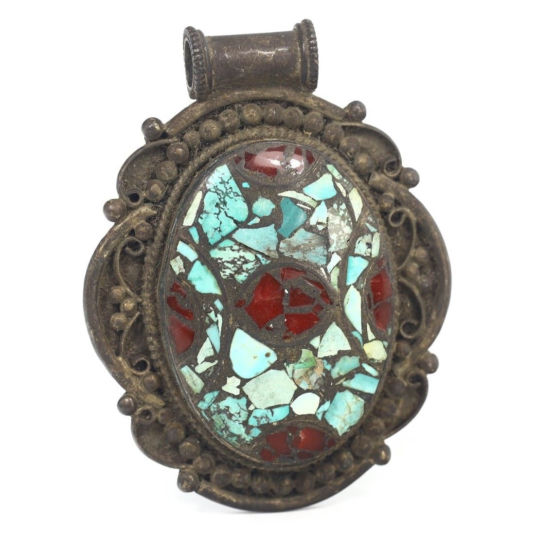 An Antique Tibetan Silver, Turquoise, and Carnelian Locket Amulet Pendant: This exquisite locket amulet pendant, made from silver and adorned with turquoise and carnelian chips. It exemplifies the intricate craftsmanship and spiritual significance of Tibetan culture during t