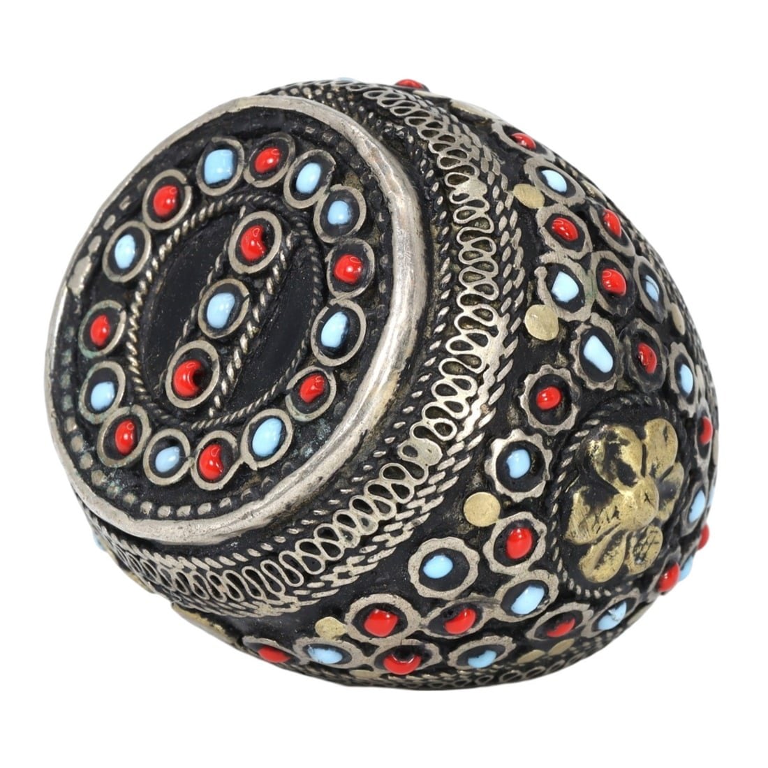 An Antique Mughal Gilt Silver Cocktail Ring: This exquisite cocktail ring, made from gilt silver and adorned with a colored stone, exemplifies the intricate craftsmanship and luxurious aesthetic of the Mughal period. This ring showcases the deta