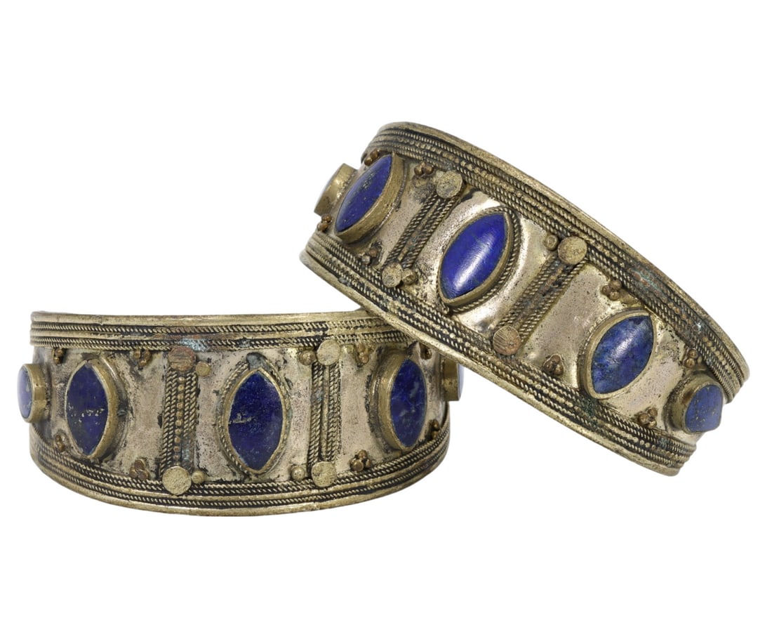 Traditional Tribal Middle Eastern Lapis Lazuli and Alloy Cuff Bracelets: This lapis lazuli and metal alloy cuff bracelet pair exemplifies the exquisite craftsmanship and cultural significance of traditional tribal Middle Eastern jewelry. Adorned with rich blue lapis lazuli