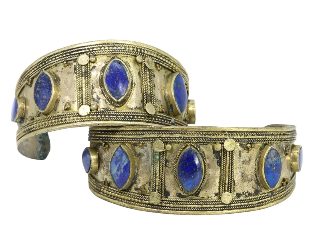 Traditional Tribal Middle Eastern Ethnic Brass and Lapis Lazuli Cuff Bracelets: This pair of brass and lapis lazuli cuff bracelets exemplifies the rich craftsmanship and cultural significance of Middle Eastern traditional tribal artistry. Adorned with vibrant lapis lazuli set wit