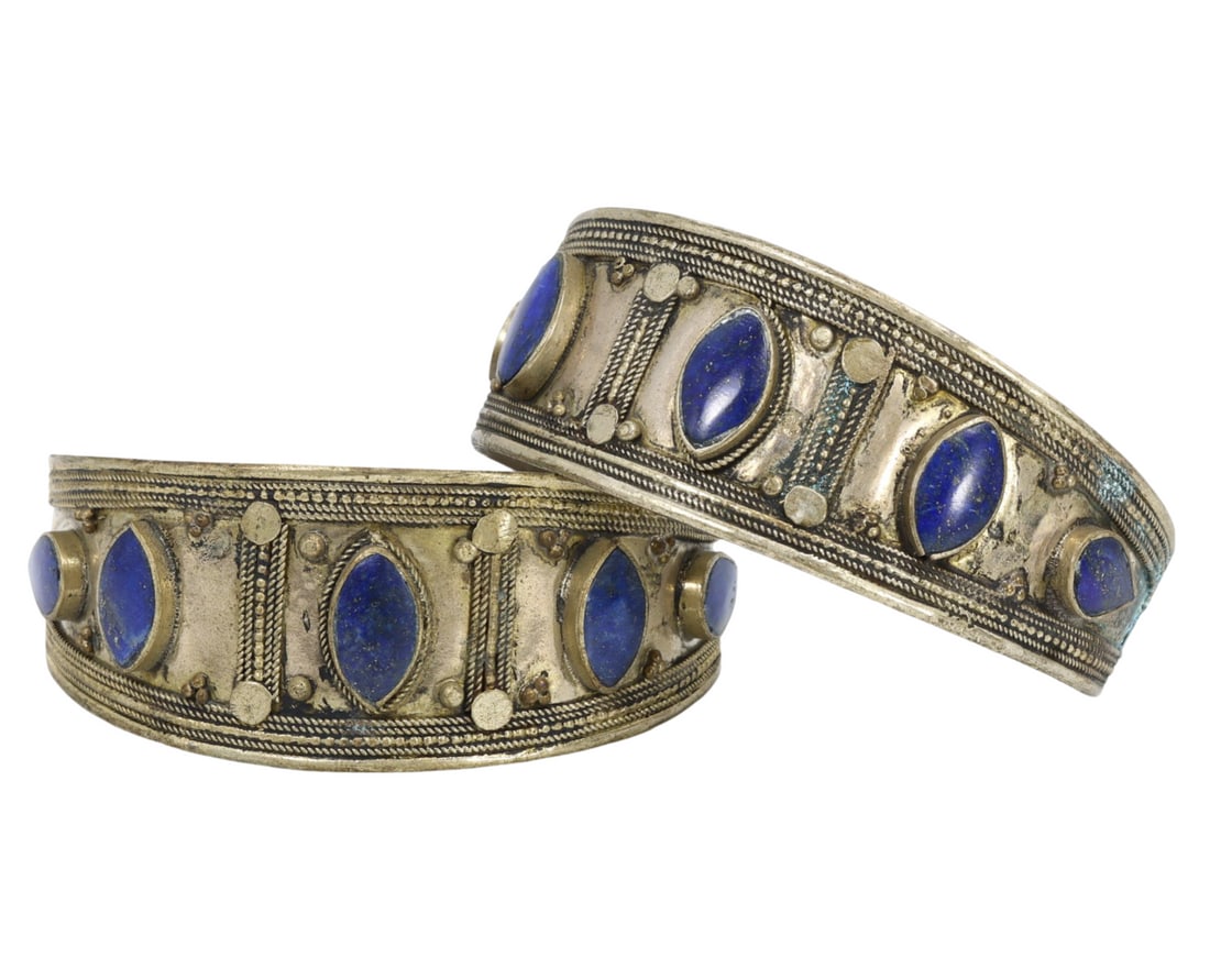 Traditional Middle Eastern Tribal Lapis Lazuli and Alloy Cuff Bracelets: This pair of Lapis Lazuli and metal alloy cuff bracelets exemplifies the intricate craftsmanship and deep cultural significance of Middle Eastern tribal jewelry. Each bracelet is adorned with striking