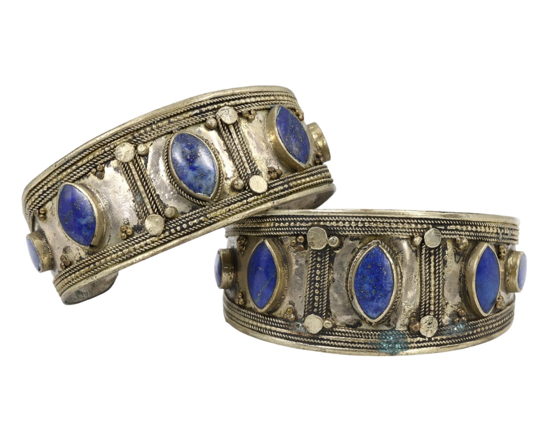 Traditional Tribal Middle Eastern Ethnic Silver Lapis Lazuli Bracelets: This silver and lapis lazuli bracelet set exemplifies the exquisite craftsmanship and rich cultural significance of traditional tribal Middle Eastern jewelry. The two matching cuff bracelets are beaut