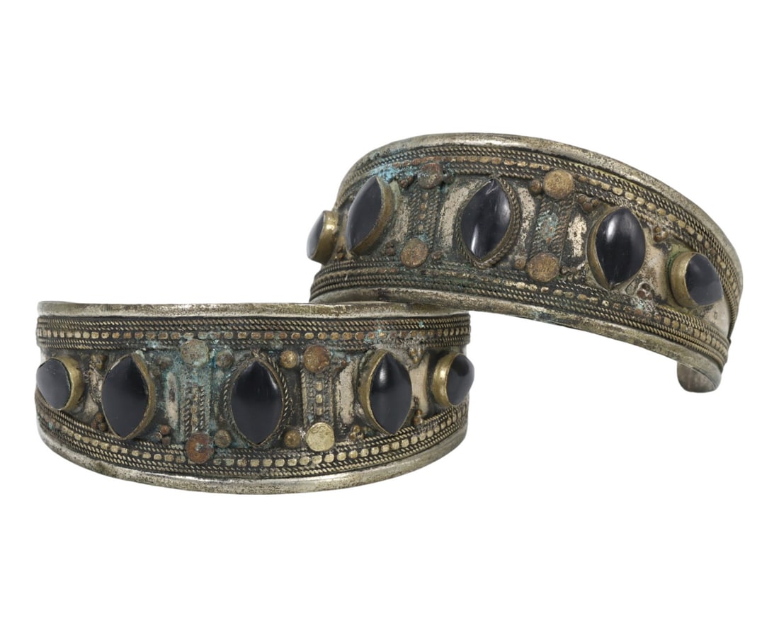 Traditional Middle Eastern Tribal Onyx Alloy Cuff Bracelets: This pair of metal alloy cuff bracelets, adorned with black onyx stones, exemplifies the intricate craftsmanship and rich cultural significance of Middle Eastern traditional tribal jewelry. The detail
