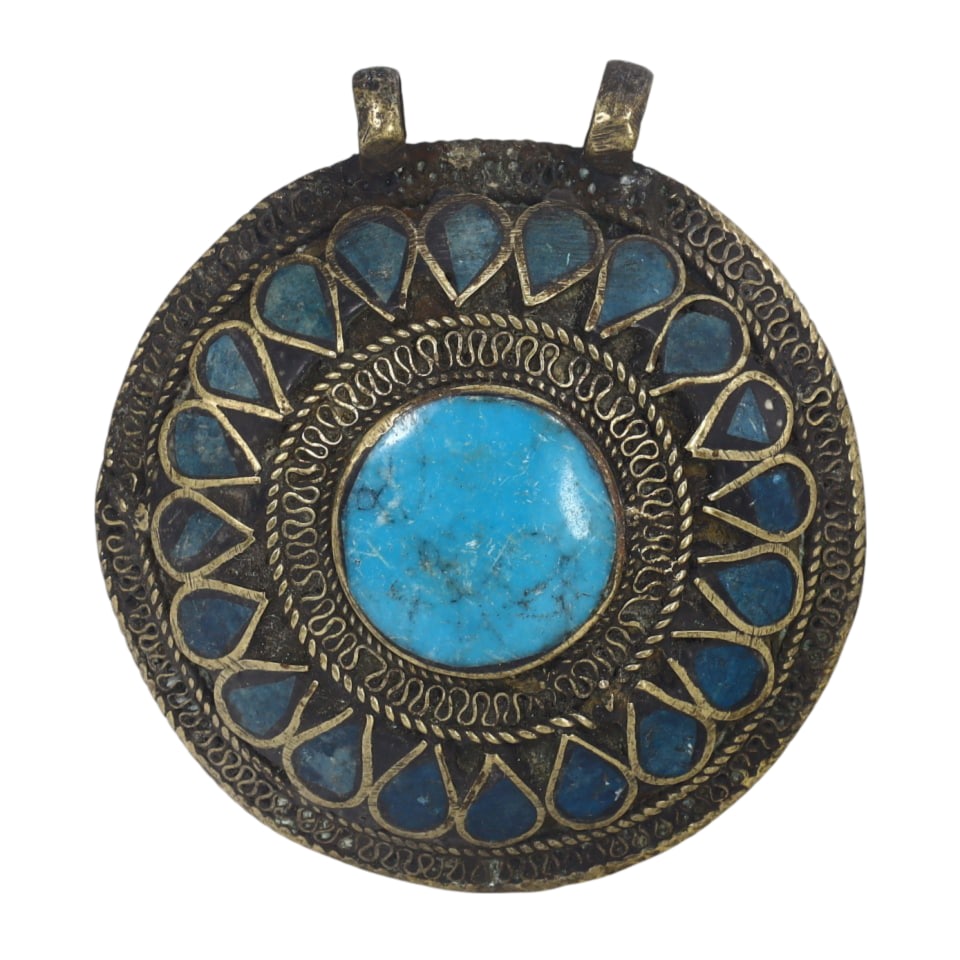 Himalayan Antique Circular Bronze Pendant with Blue Stone: This circular bronze pendant features a central blue stone surrounded by intricate patterns, showcasing the ornate metalwork typical of Himalayan artisans. The symbolic inlay and detailed design refle