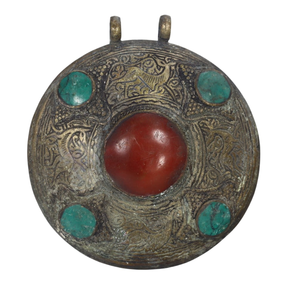 Himalayan Antique Circular Bronze Pendant with Turquoise and Coral: This circular bronze pendant features a central red stone surrounded by turquoise accents and intricate patterns, showcasing the ornate metalwork typical of Himalayan artisans. The symbolic inlay and