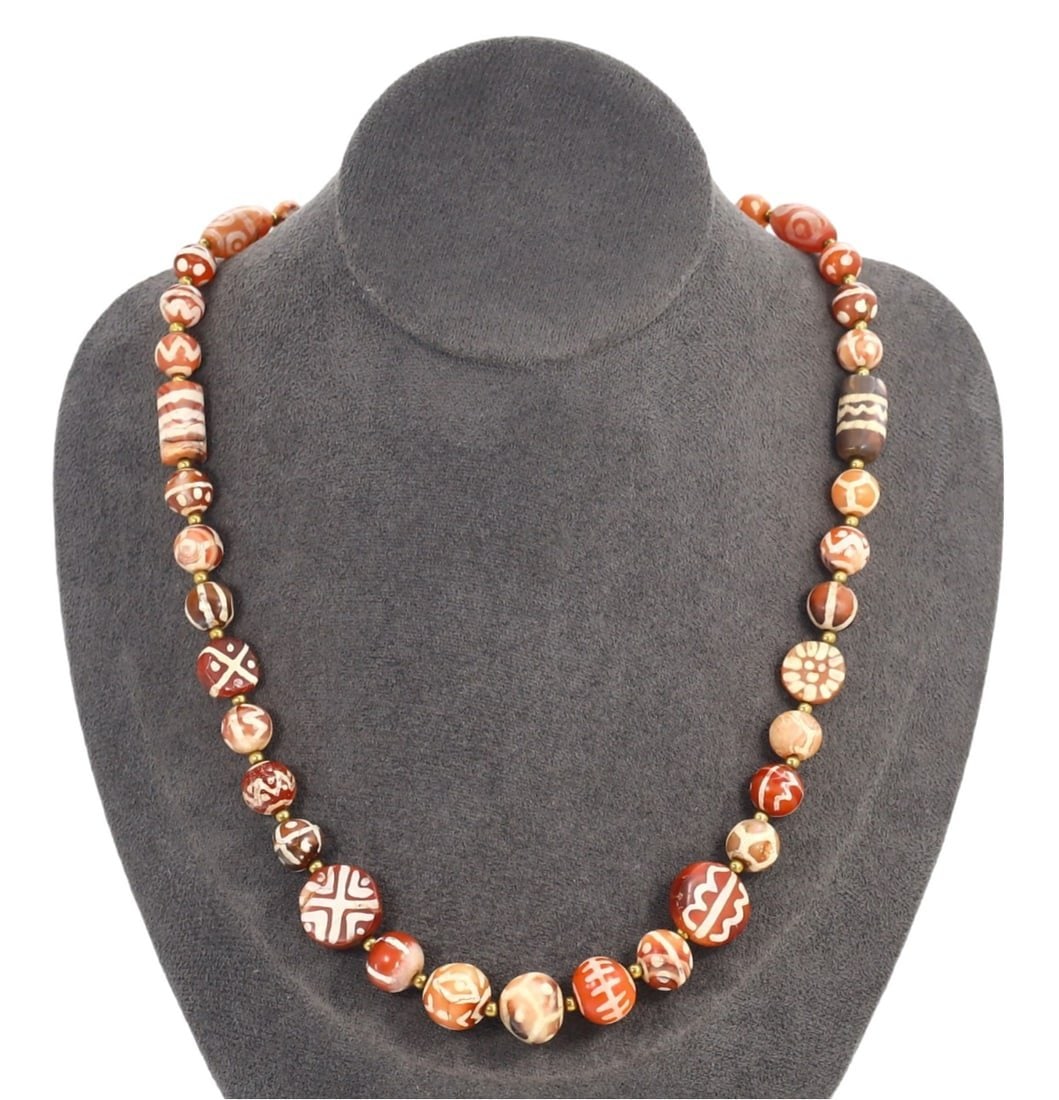 Antique Indo-Himalayan Tibetan Etched Carnelian Beaded Necklace: This etched carnelian beaded necklace exemplifies the expert craftsmanship and deep cultural significance of the Indo-Himalayan region. Each bead is meticulously adorned with intricate white patterns 