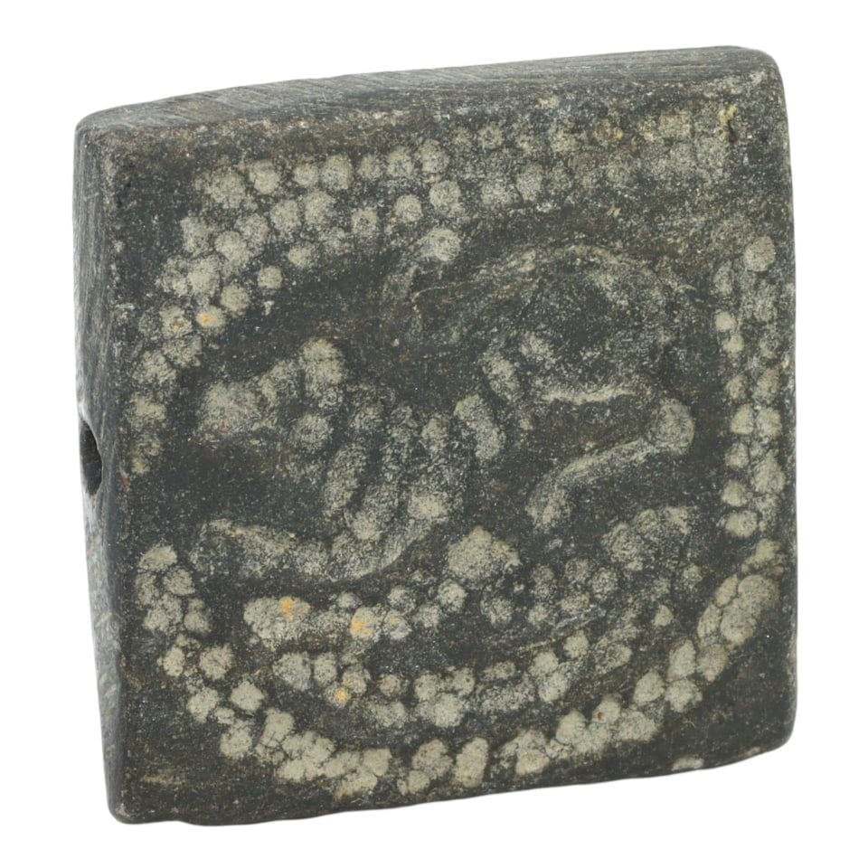 An Ancient Parthian Basalt Double Convex, c. 247 BC - 224 AD: This double convex artifact, made from main basalt, exemplifies the meticulous craftsmanship and cultural significance of the Parthian era. Such objects were commonly used for architectural and decora