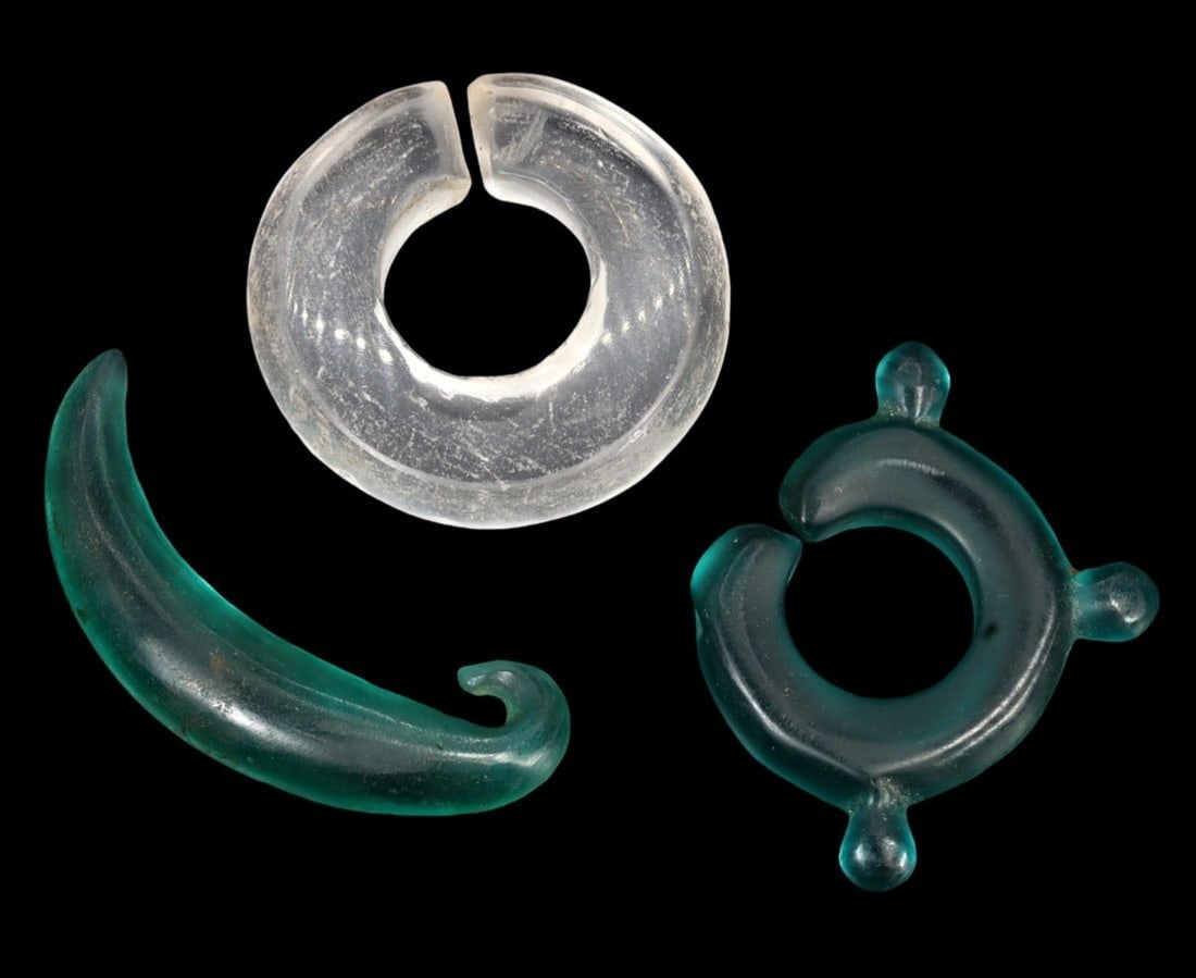 Traditional Vietnamese Monochrome Glass Earrings Set: This monochrome glass earrings set exemplifies the meticulous craftsmanship and rich cultural heritage of traditional Vietnamese jewelry. The various crescent-shaped earrings showcase the artisanal sk