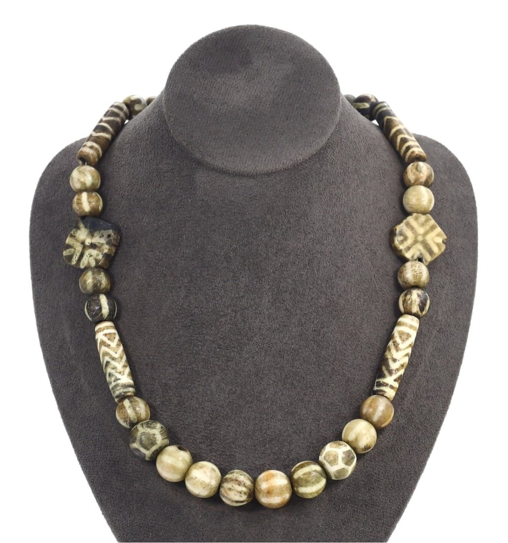 Antique Tibetan Ethnic Etched Palm Wood Beads Necklace: This Etched Palm Wood Beads Necklace exemplifies the rich craftsmanship and cultural significance intrinsic to Tibetan ethnic art. The necklace features varied palm wood beads with distinctive pattern