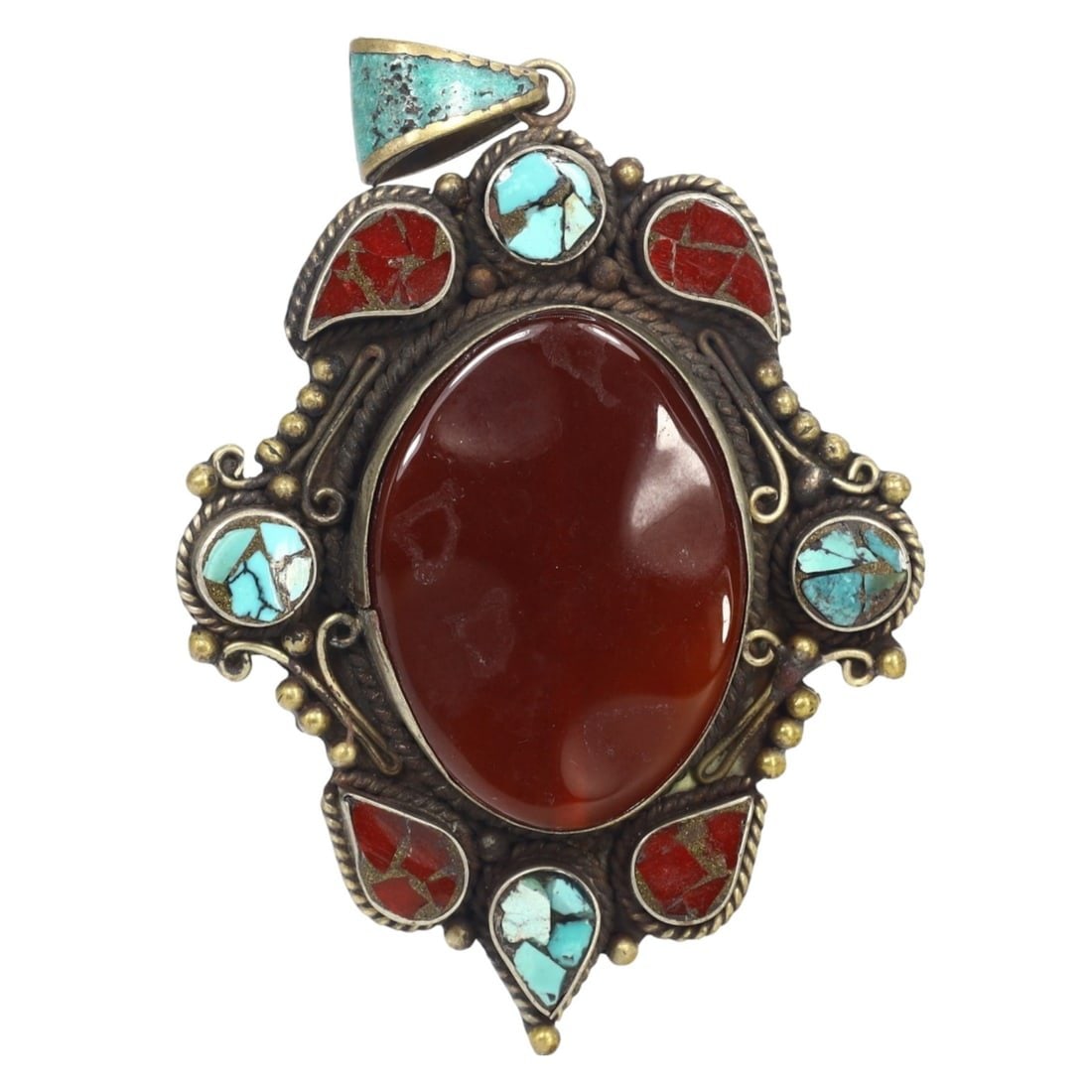 Antique Tribal Afghan Ethnic Silver Carnelian and Turquoise Pendant: This silver, carnelian and turquoise pendant exemplifies the intricate craftsmanship and cultural significance of Afghan ethnic jewelry. Pendants like this were commonly worn as amulets or decorative