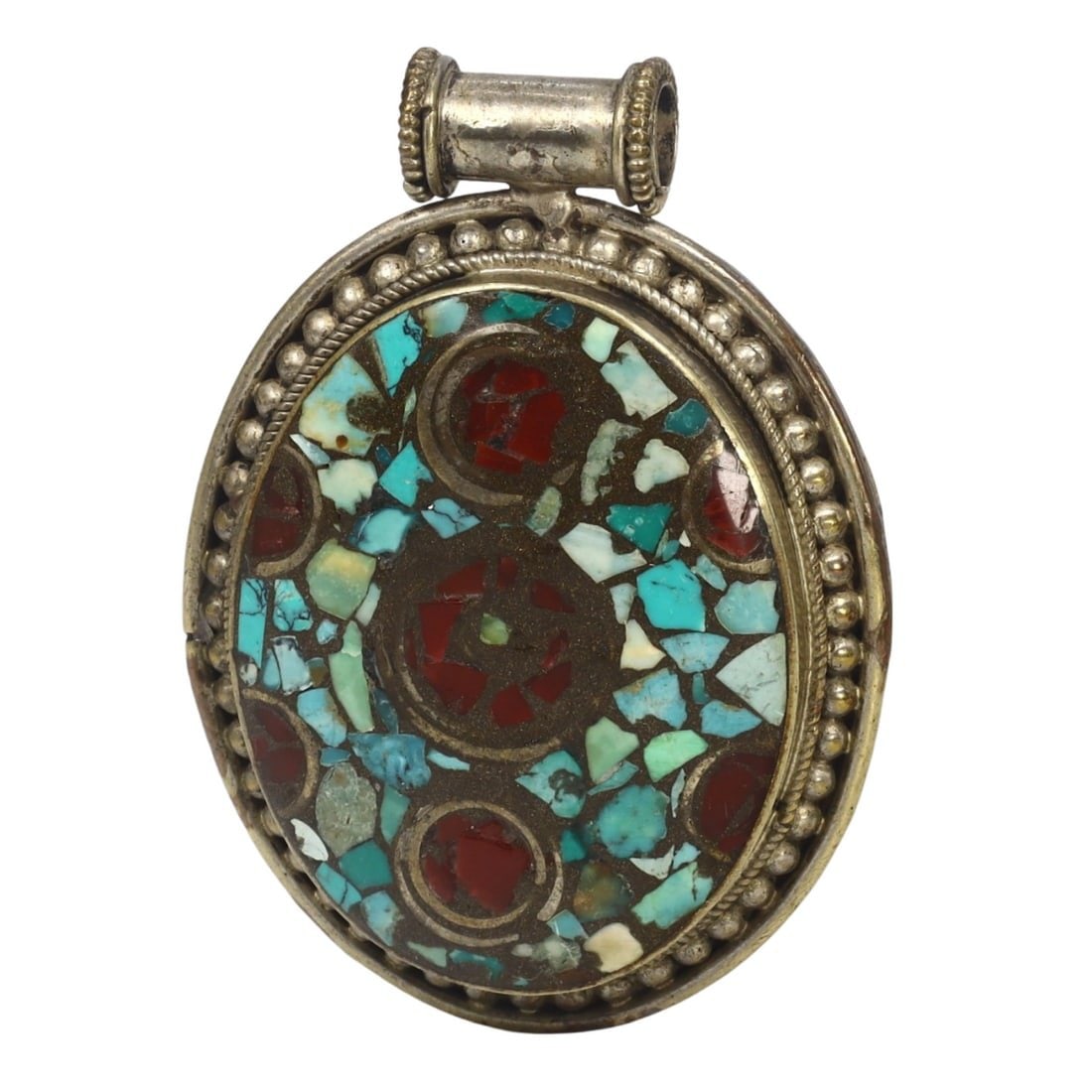 Antique Tribal Afghan Ethnic Silver Carnelian and Turquoise Pendant: This silver, carnelian and turquoise pendant exemplifies the intricate craftsmanship and cultural significance of Afghan ethnic jewelry. Pendants like this were commonly worn as amulets or decorative