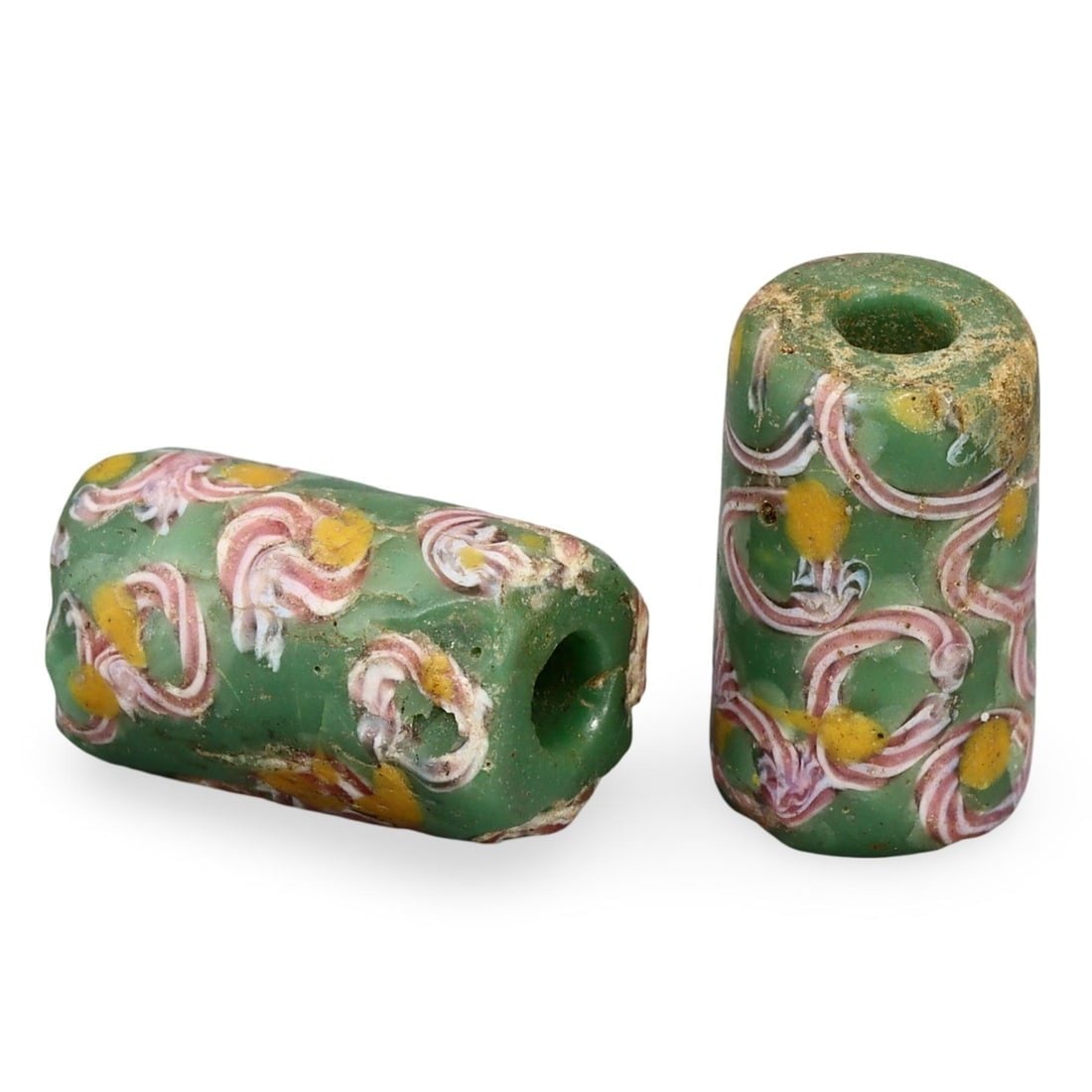 Lot of 2 Post Medieval West African Venetian Millefiori Trade Beads, 19th Century: This lot comprises two exquisite Venetian millefiori trade beads from the Post Medieval West African trade networks, dating back to the 19th century. These cylindrical beads feature vibrant green back