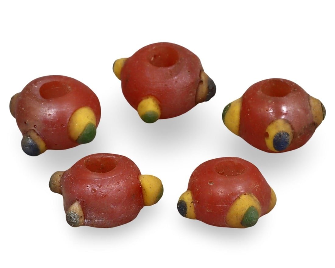 Ancient Carthaginian Stratified Knobbed Eye Glass Beads, 3rd-1st Century BC: This lot includes stratified knobbed eye glass beads from the Ancient Carthaginian period, dating back to the 3rd-1st century BC. Each bead features the distinctive knobbed eye design, crafted from gl