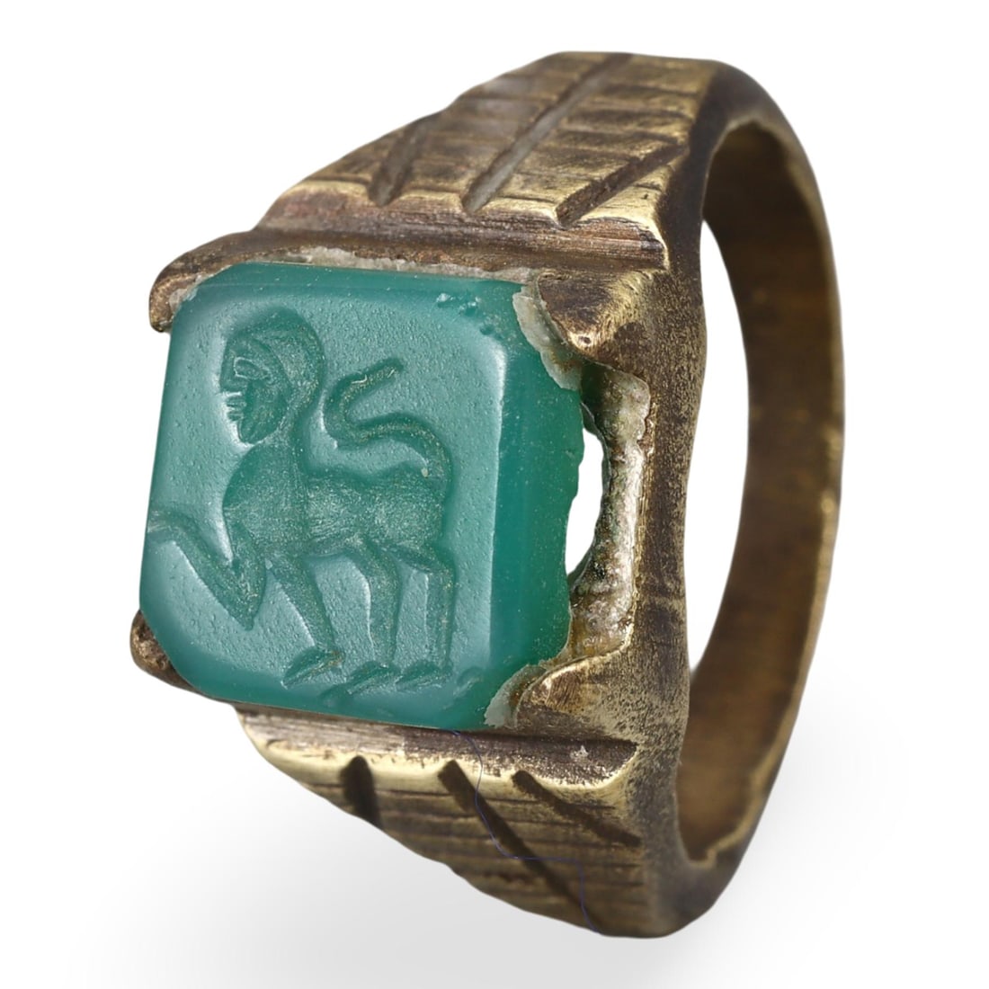 Ancient Intaglio in Post Medieval Copper Alloy Ring Setting, 18th-19th Century: This unique artifact features an ancient intaglio set in a post-medieval copper alloy ring, combining elements from different historical periods. The intaglio, intricately carved with a figure, showca