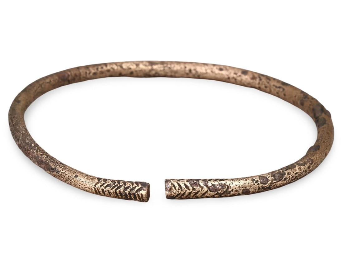 Authentic Ancient Medieval Viking / Celtic / Livonian Bronze Bracelet, 11th-13th Century: This Authentic Ancient Medieval bracelet, dating from the 11th-13th century, is a remarkable artifact from the Viking, Celtic, or Livonian cultures. Crafted from bronze, the bracelet features intricat