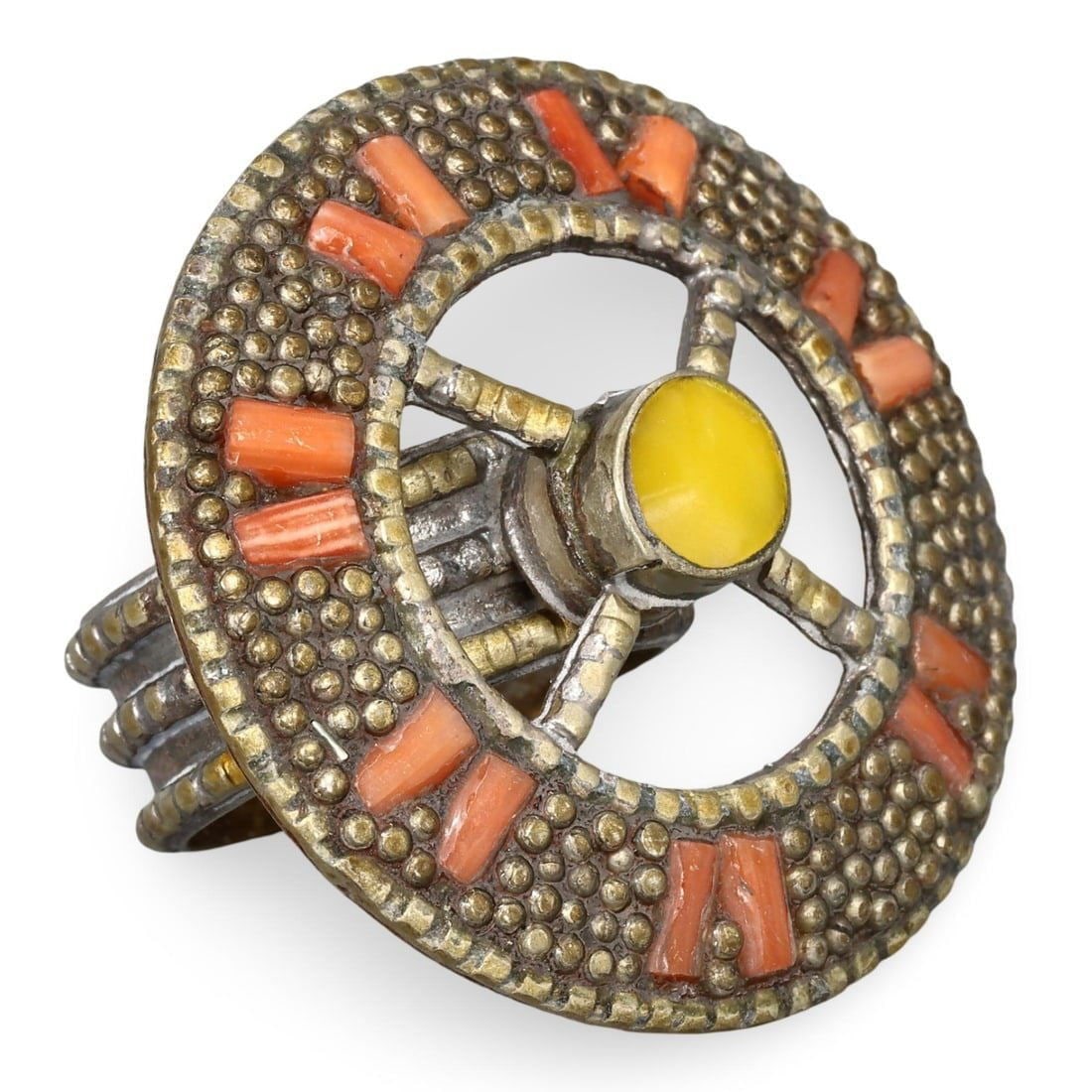 Ottoman Dynasty Silver-Gilt Ring with Coral Set and Pseudo-Granulation Design, 19th Century: This ring from the Ottoman Dynasty is crafted from enamelled silver-gilt and features a coral set with a pseudo-granulation design. Dating back to the 19th century, such rings were typically worn as s