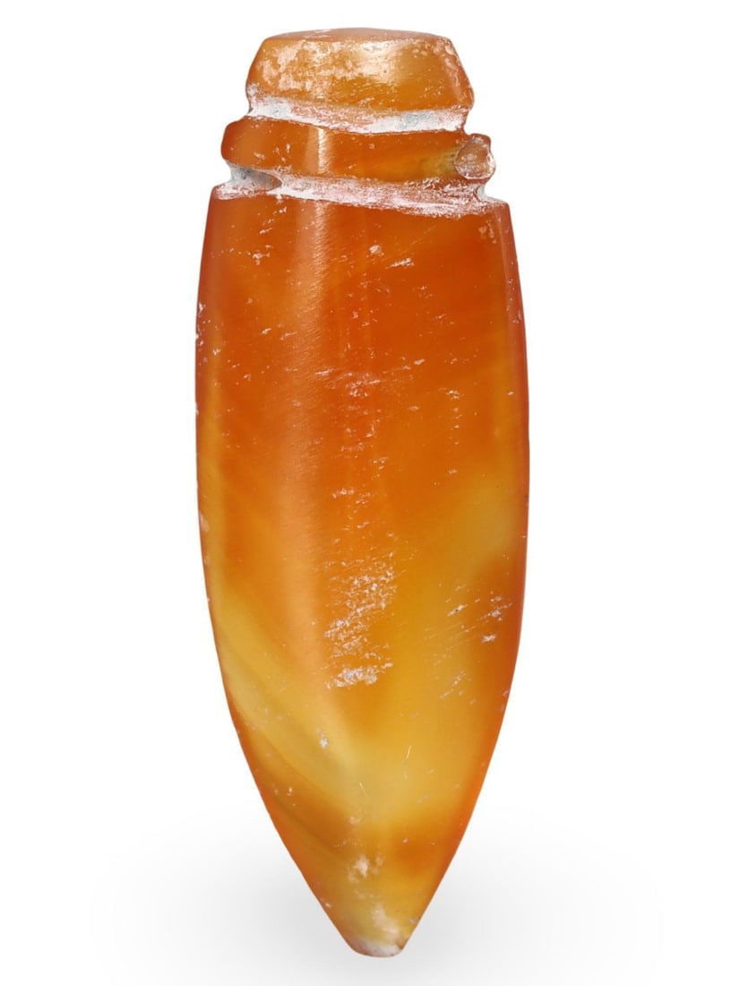 Ancient Medieval Pyu Pagan Carnelian Sword Dagger Amulet Bead, 9th-13th Century: This Ancient Medieval Pyu Pagan amulet bead, dating from the 9th-13th century, is crafted from vibrant carnelian and shaped into a stylized sword or dagger. Such amulets were highly valued in the Pyu