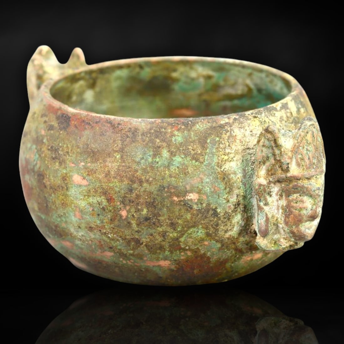 Rare Luristan Bronze Ritual Bowl with Human Bust Handles, Circa 9th Century BCE: This ceremonial bronze bowl originates from ancient Luristan, an area renowned for its sophisticated bronze artisanship, located in the western Zagros mountains of present-day Iran. Dated to the 9th c