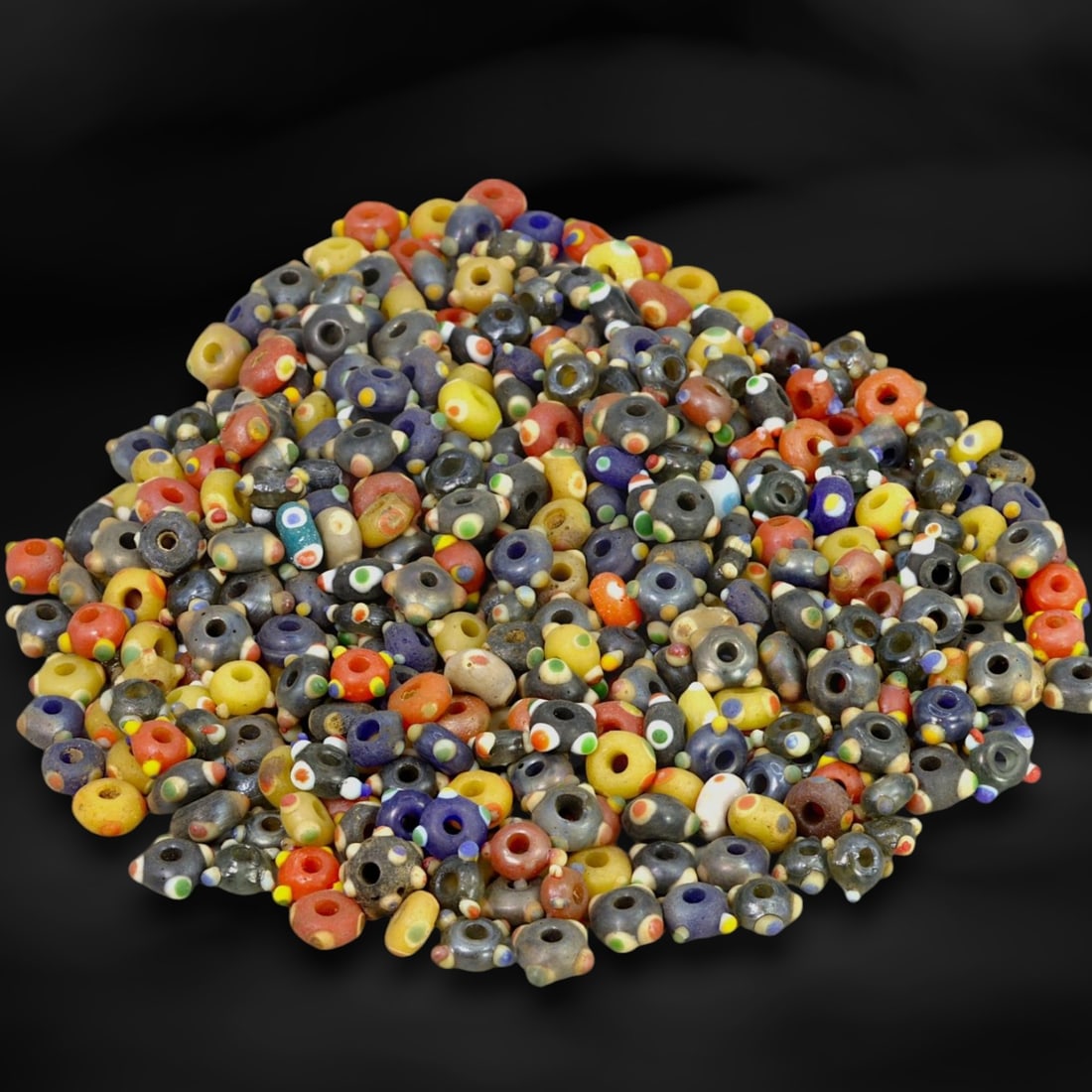 Ancient Medieval Venetian Millefiori Eye Glass Beads, c. 9th-15th Century CE: This collection of ancient Venetian millefiori "eye" glass beads, dating from the 9th to 15th centuries, showcases the vibrant artistry and cultural depth of medieval Venetian glassmakers. Venice, a r