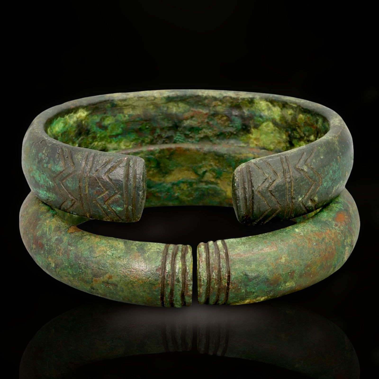 Ancient Celtic Unity and Protection Symbolic Bronze Cuff Bracelets, c. 3rd-2nd Century BCE: This exquisite pair of ancient Celtic bronze cuff bracelets, dating from approximately the 3rd-2nd century BCE, embodies the artistry and symbolic depth of Celtic craftsmanship. Each bracelet, with a