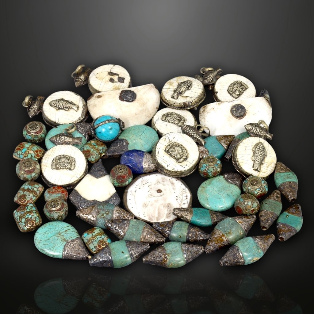 Ancient Tibetan Ritual Bead Collection with Silver Inlays, c. 15th-17th Century: This remarkable assortment of 45 ancient Tibetan ritual beads, crafted between the 15th and 17th centuries, offers a rare insight into the spiritual and artistic traditions of historic Tibet. Weighing