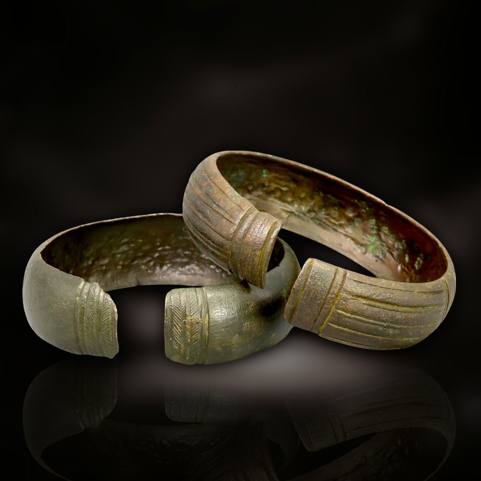 Ancient Celtic Warrior's Bronze Cuff Bracelets, c. 1st Century BCE - 1st Century CE: These robust bronze cuff bracelets, dating back to the 1st century BCE - 1st century CE, are striking examples of Celtic craftsmanship, reflecting the warrior culture and artistry of ancient Celtic so