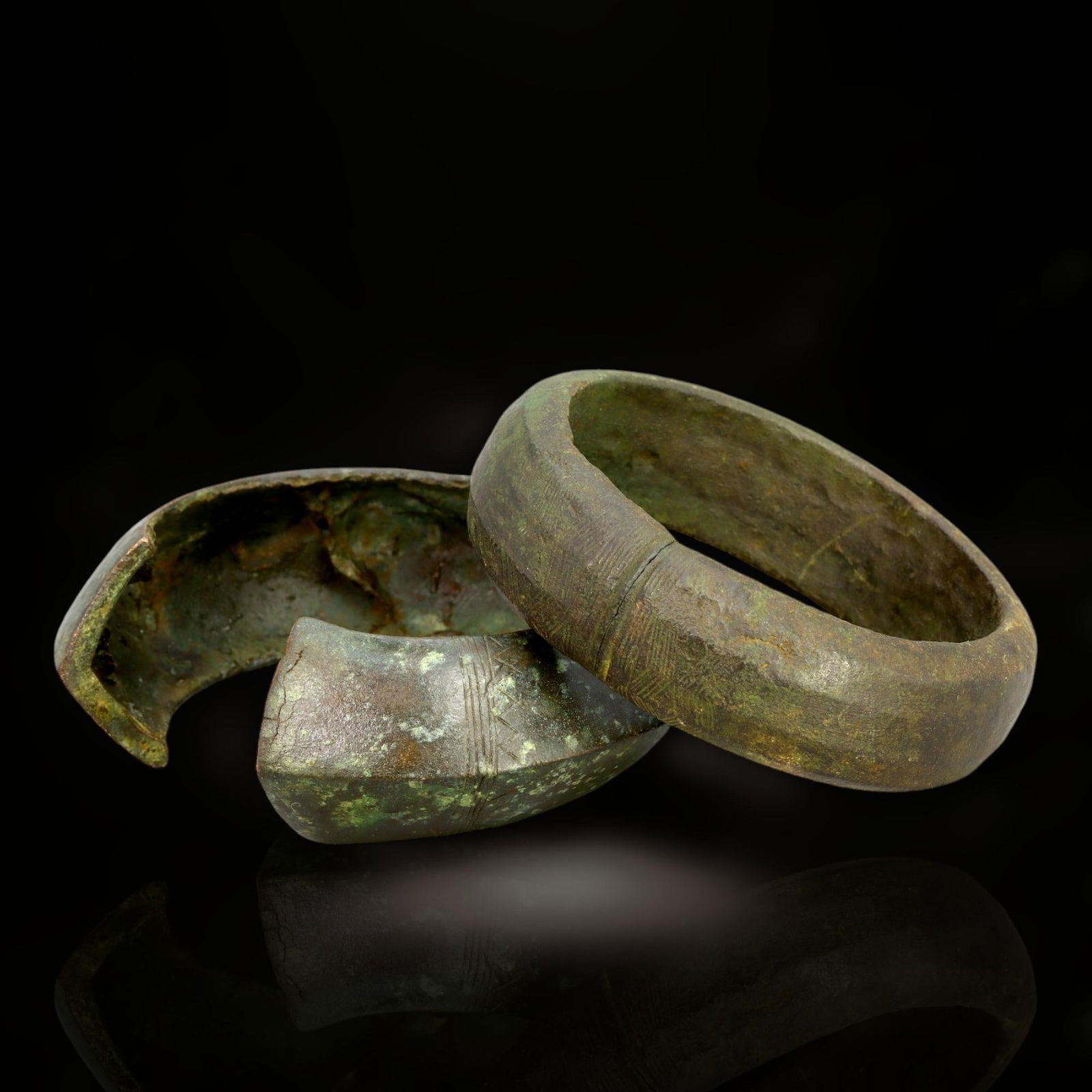 Ancient Celtic Bronze Warrior's Cuff Bracelets, c. 1st Century BCE - 1st Century CE: This impressive pair of Celtic bronze cuff bracelets, dating to the 1st century BCE - 1st century CE, exemplifies the robust design and symbolic artistry characteristic of ancient Celtic craftsmanship
