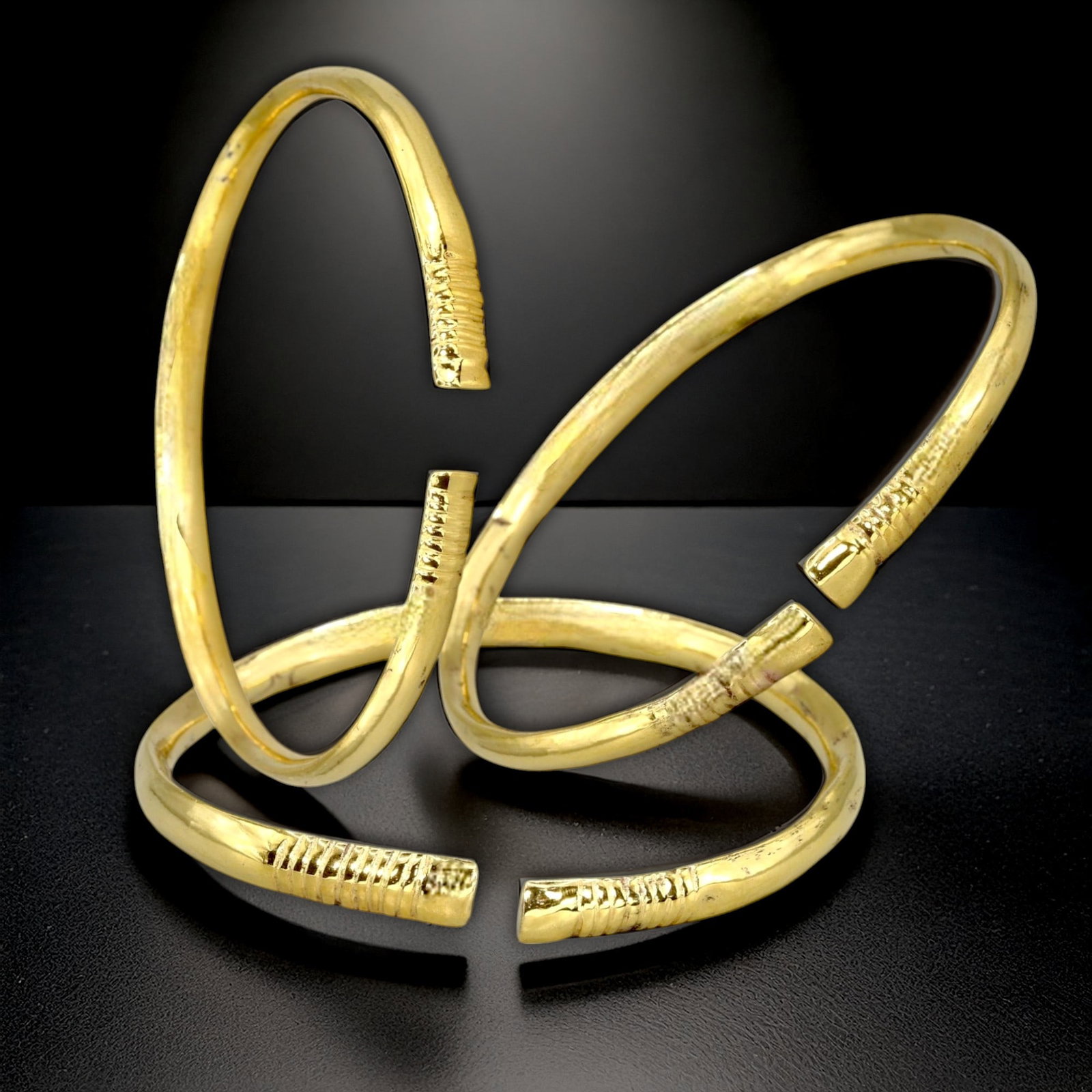 Ancient Byzantine Bronze Bracelets with 24K Gold Gilding, c. 6th-9th Century CE: This impressive set of three Byzantine bronze bracelets, each gilded in rich 24K gold, showcases the sophisticated artistry and cultural symbolism of the Byzantine Empire. Dating from the 6th to 9th c