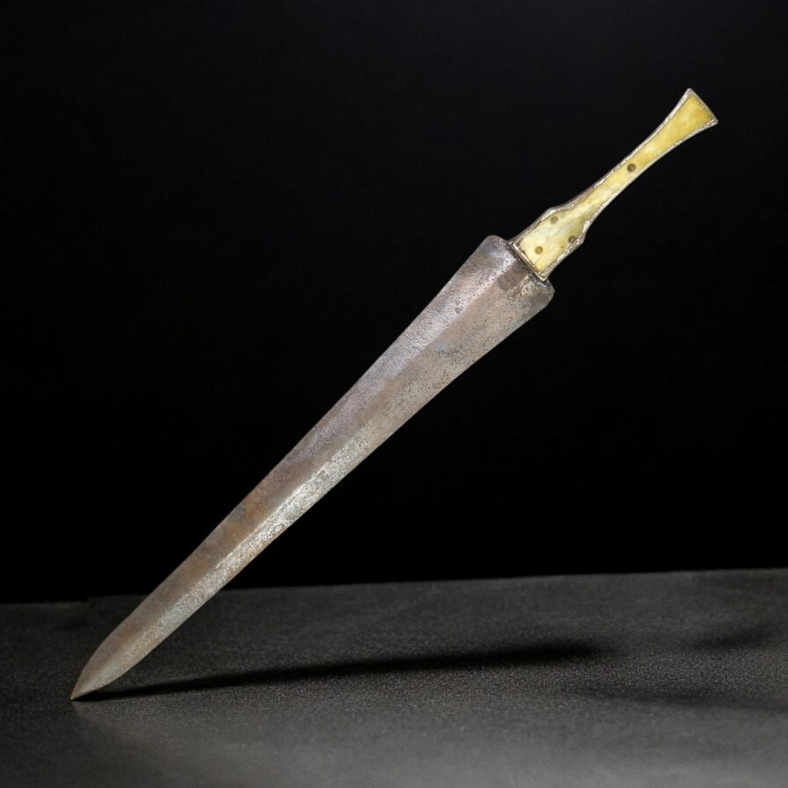 LURISTAN BRONZE DAGGER/SWORD, WESTERN IRAN, CIRCA 1200-800 BCE (42cm, 293g): This is a remarkable example of a Luristan bronze dagger or short sword from the Late Bronze to Early Iron Age, circa 1200-800 BCE, crafted in western Iran. Measuring 42cm in length and weighing 293g,