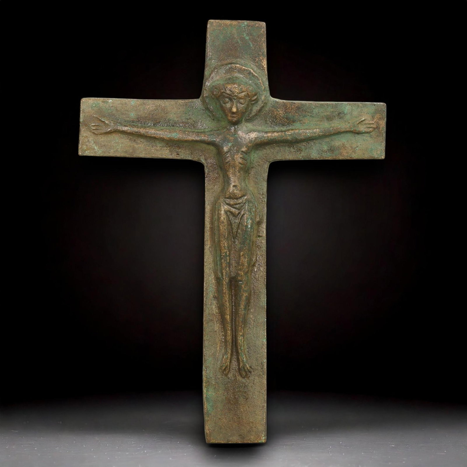 MEDIEVAL PERIOD: Bronze Crucifix, 12th-15th Century: This bronze crucifix, measuring 12.5 cm in height and 9 cm in width, with a weight of 130 g, is a striking artifact from the medieval period. The central figure of Christ, depicted with elongated arms