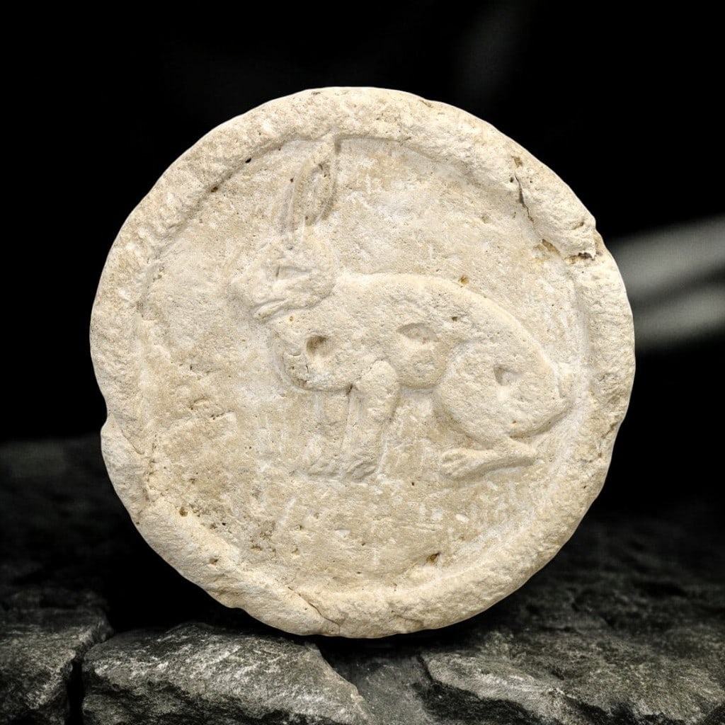 BYZANTINE EMPIRE: Ancient Pottery Moulded Stamp with Rabbit Motif, 5th-7th Century CE: This delicate pottery stamp, weighing 248 grams and measuring 10 cm in diameter, features a finely moulded rabbit motif within a circular frame. Likely used for decorative purposes, the stamp reflects