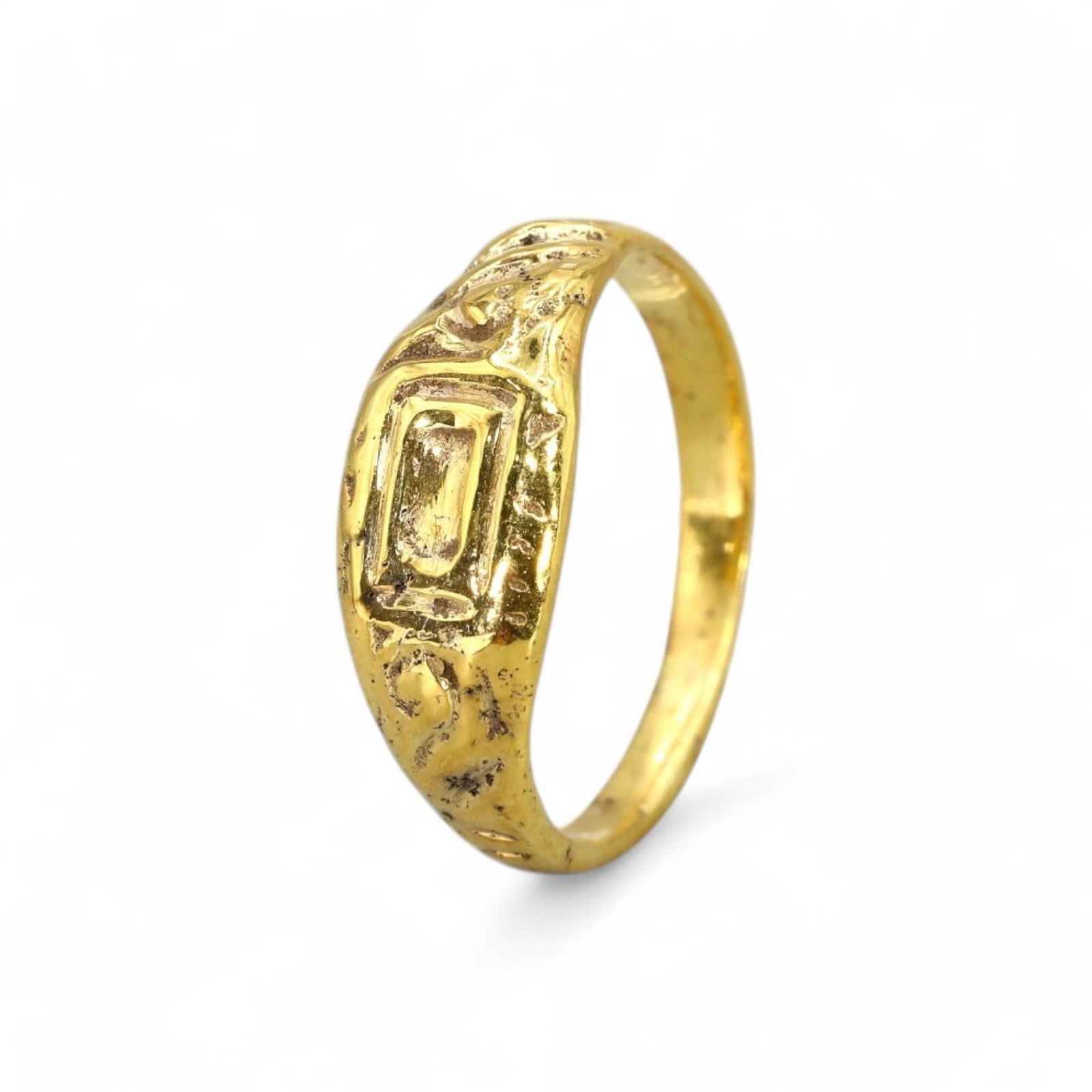 BYZANTINE ERA: Bronze Ring with 24K Gold Gilt, 6th-9th Century CE (2g, US Size 5): This delicate Byzantine bronze ring, richly gilded with 24K gold, features an inset rectangular bezel flanked by intricate scrollwork patterns. The design reflects the artistic sophistication of the B