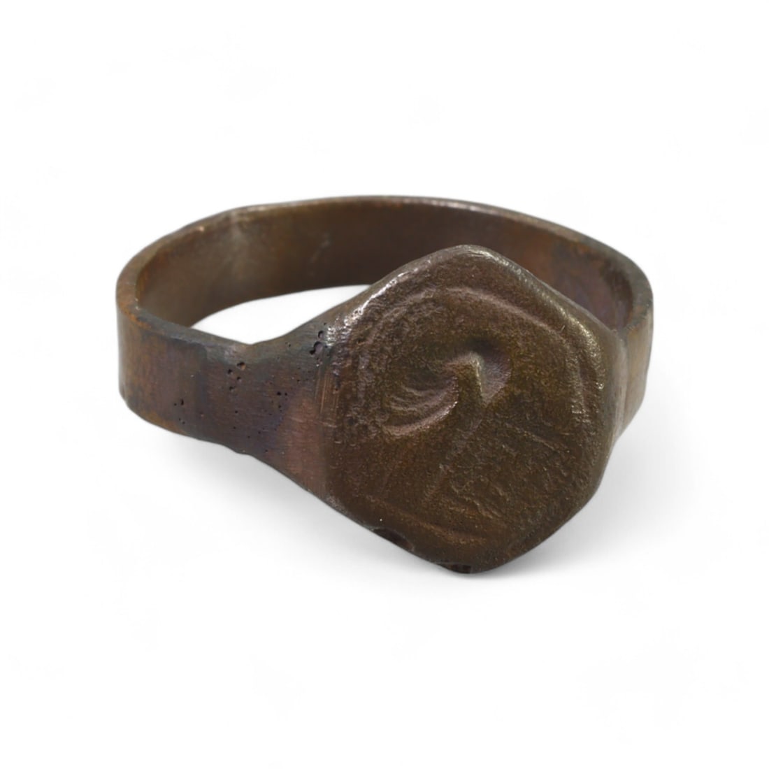 MEDIEVAL ERA: Bronze Signet Ring with Curvilinear Motif, 13th-15th Century CE (9.5 US, 4g): This medieval bronze signet ring features a hexagonal bezel engraved with a stylized curvilinear design, suggestive of personal or symbolic meaning. Its robust band and darkened patina speak to its en
