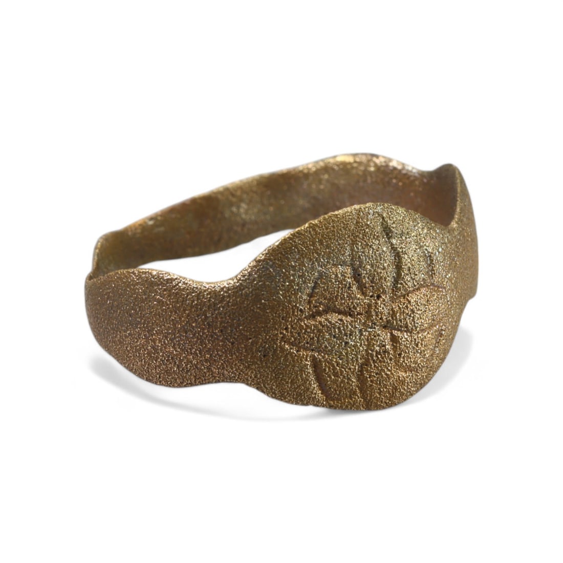 MEDIEVAL ERA: Bronze-Gilt Signet Ring with Floral Engraving, 14th-16th Century CE (2g, 8 US): This delicate bronze signet ring from the Medieval era features an elegant, engraved floral motif on its oval bezel. The lightly curved band and refined craftsmanship suggest its use as both a persona