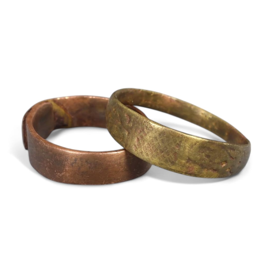 PAIR OF MEDIEVAL BRONZE AND COPPER-ALLOY BAND RINGS, 13th-15th Century CE (Sizes 6-10 US, 6g): This pair of Medieval band rings, crafted from bronze and copper-alloy, features smooth, unadorned bands that emphasize simplicity and functionality. Likely used as everyday adornments or symbols of c
