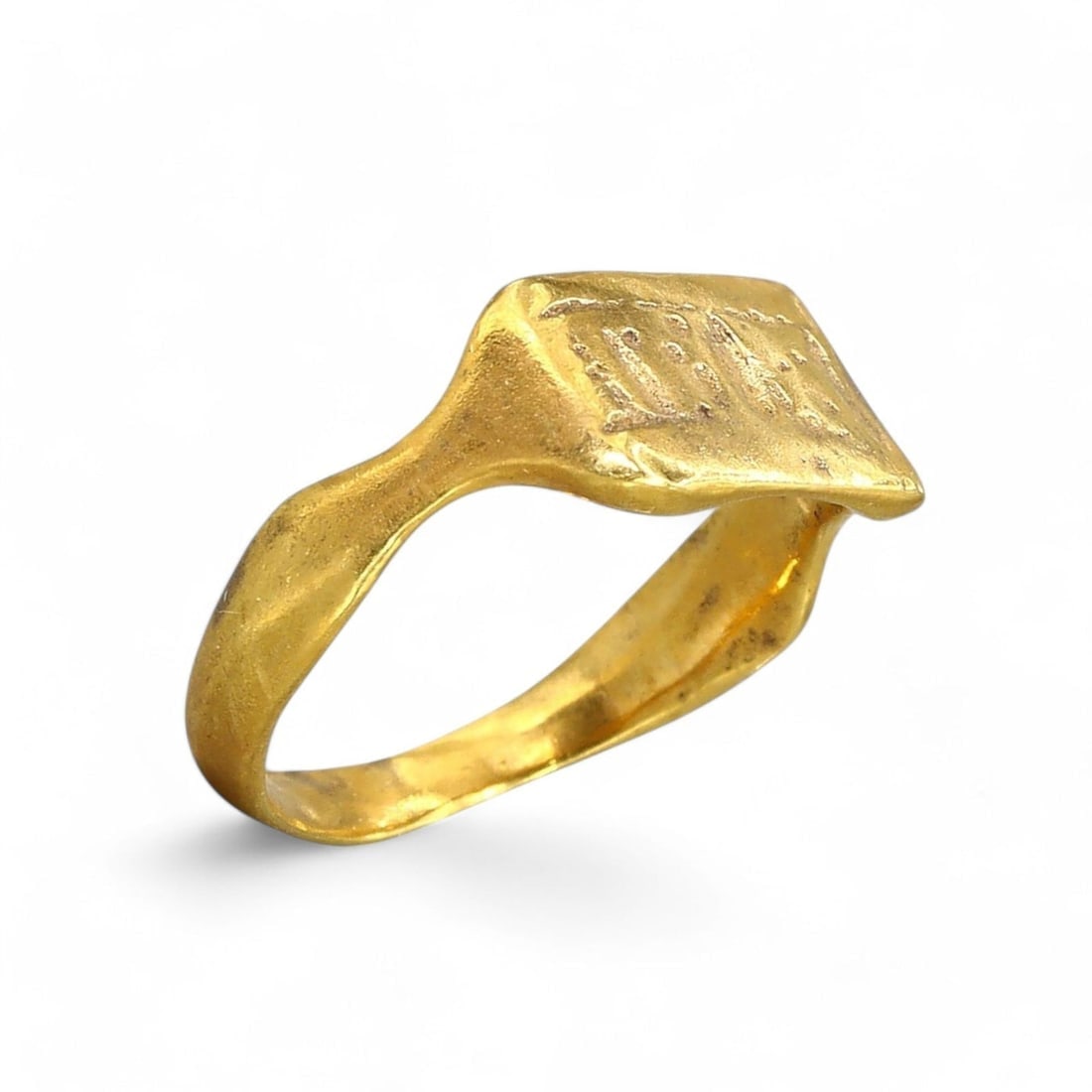 BYZANTINE EMPIRE: Child's Gold-Gilt Bronze Rectangular Signet Ring, 6th-9th Century CE (1.3g, 1 US): This diminutive Byzantine-era signet ring, expertly crafted from gold-gilt bronze, features a rectangular bezel with faint inscriptions, hinting at its role in personal identification or symbolic use.