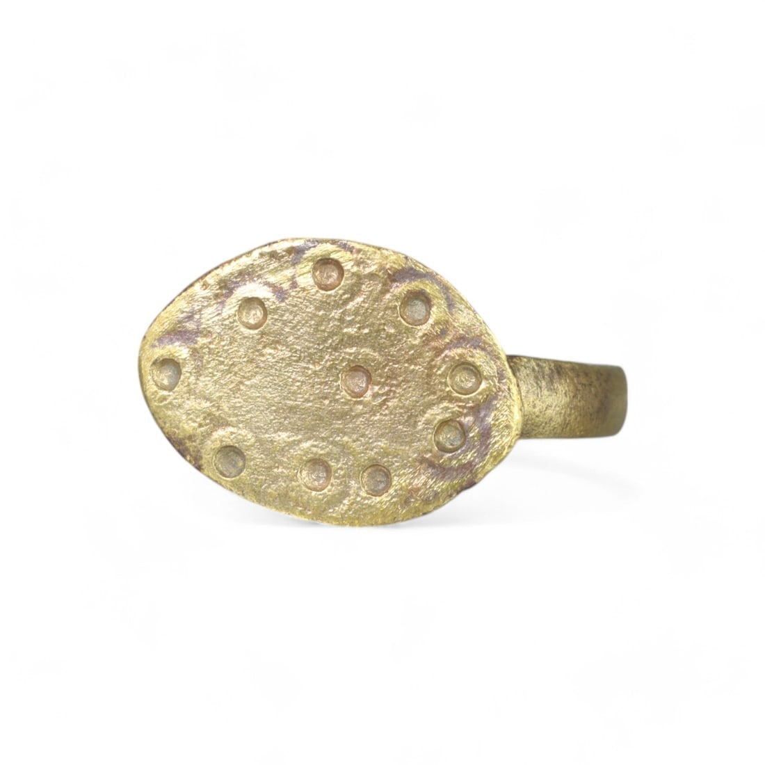 BYZANTINE: Gold-Gilt Bronze Ring with Dotted Oval Bezel, 6th-9th Century CE (2g, US Size 7.75): This elegant gold-gilt bronze ring, weighing 2g and sized at US 7.75, originates from the Byzantine period, circa 6th-9th century CE. The oval bezel is adorned with a series of evenly spaced circular 