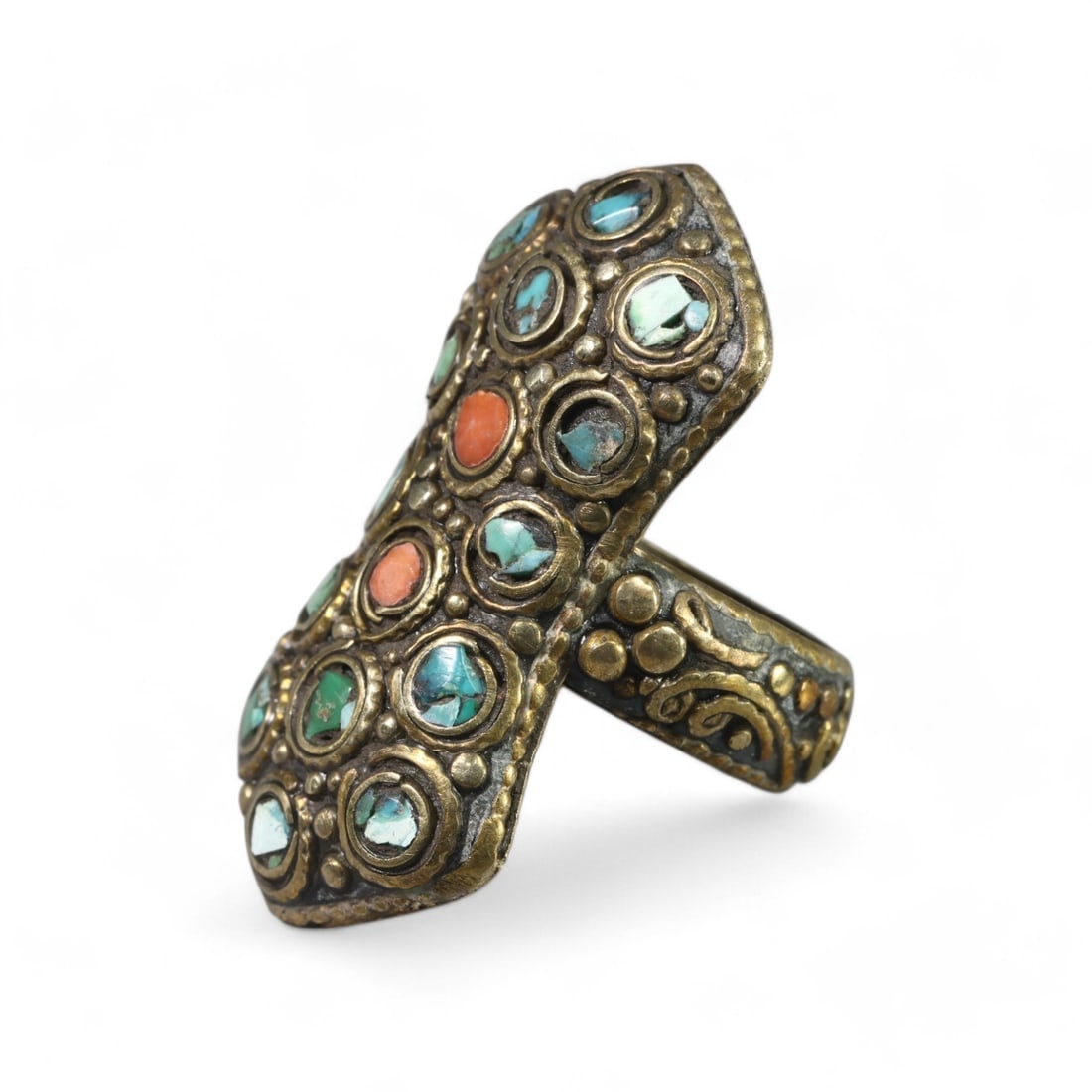 CENTRAL ASIAN: Silver Ornate Tribal Splendor Ring with Turquoise and Coral Inlays, (19g, Size 9 US): This striking Central Asian silver ring features an elongated design, richly adorned with turquoise and coral inlays set in decorative bezels. The intricate arrangement of gemstones and the textured s