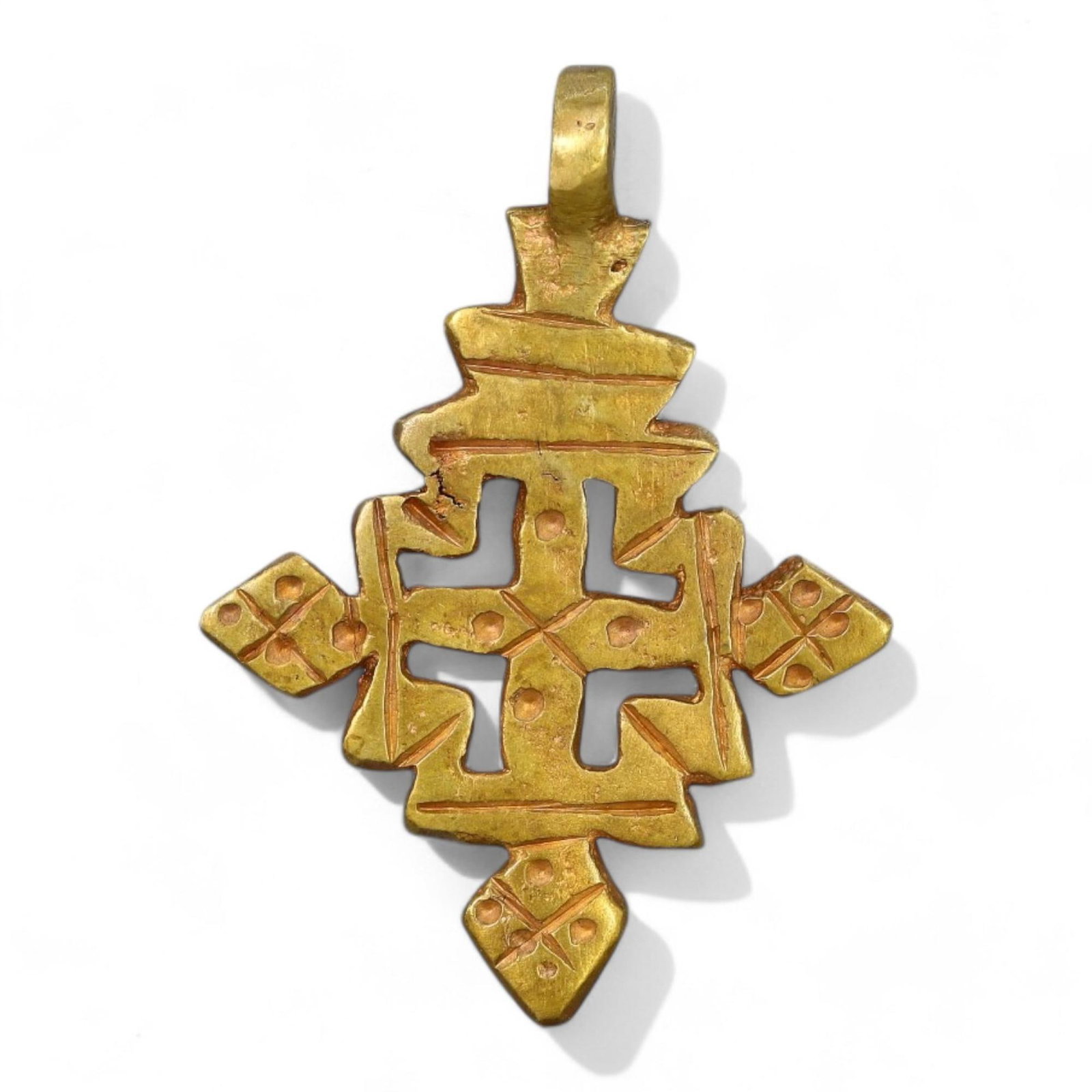 ETHIOPIAN COPTIC ERA: Gilded Bronze Cross Pendant, Circa 17th-19th Century CE (4.5x3cm, 6g): This exquisite Ethiopian Coptic cross pendant is crafted in gilded bronze, featuring intricate geometric engravings and small perforations that enhance its symbolic significance. The cross's symmetric