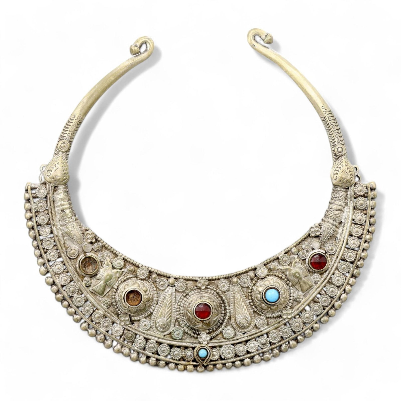 TRIBAL SILVER: Ornate Neck Torc with Gemstone Inlays, 19th-20th Century CE (19 cm, 308 g): This magnificent tribal silver neck torc is a masterpiece of craftsmanship, featuring intricate filigree patterns, repouss? details, and an array of vibrant gemstone inlays, including turquoise and re