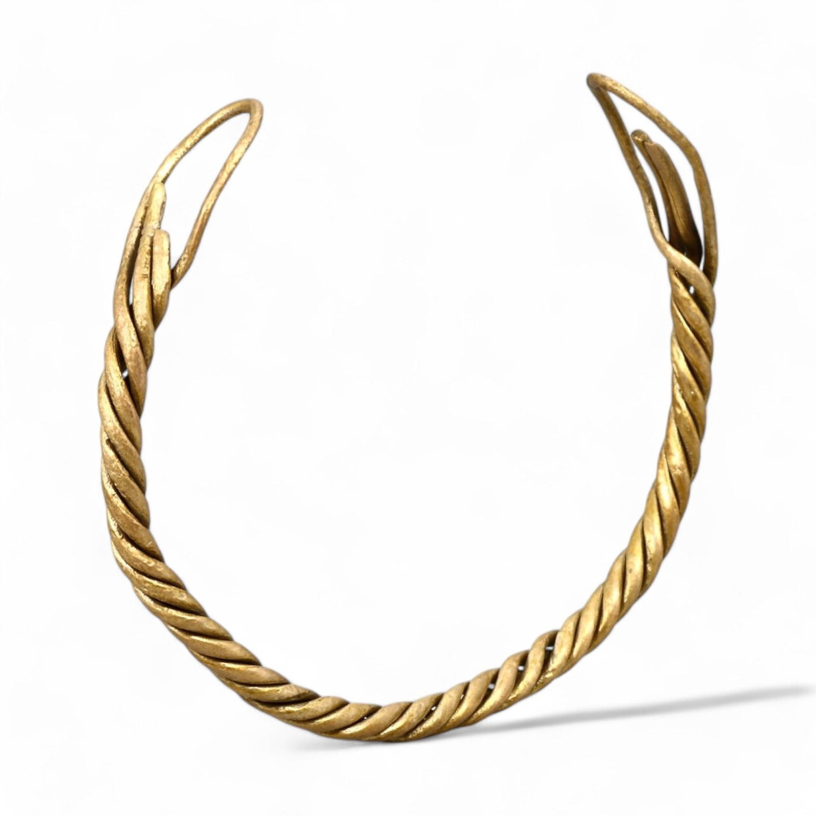 VIKING ERA: Twisted Gold-Gilt Bracelet, Circa 9th-11th Century CE (6 cm, 7 g): This elegant Viking-era bracelet showcases a twisted design, skillfully crafted from bronze and richly finished with a gold gilt. The spiral pattern is a hallmark of Viking craftsmanship, symbolizing 