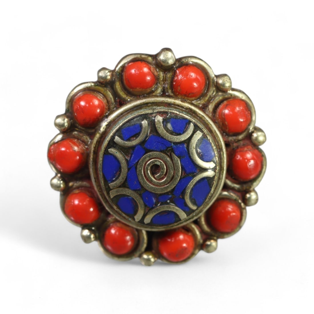 TIBETAN: Silver "Spiral Cosmos" Ring with Lapis and Coral Accents, Vintage (6g, Size 6 US): This vibrant Tibetan silver ring features a central lapis inlay adorned with intricate spiral and crescent motifs, symbolizing cosmic balance and unity. The centerpiece is framed by a radiant arrangem